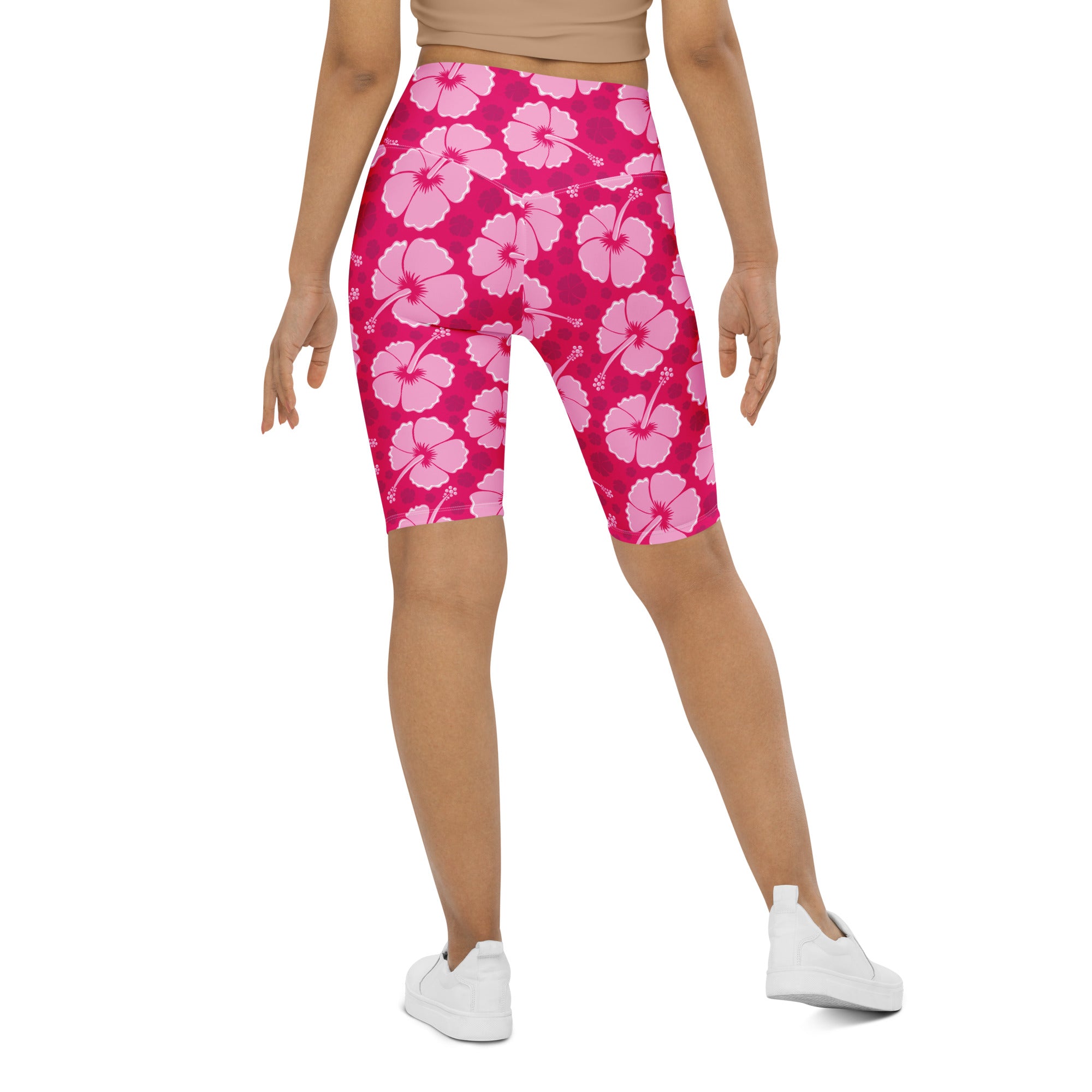 Women’s pink hibiscus high waisted biker shorts with moisture wicking fabric and active fit for workouts
