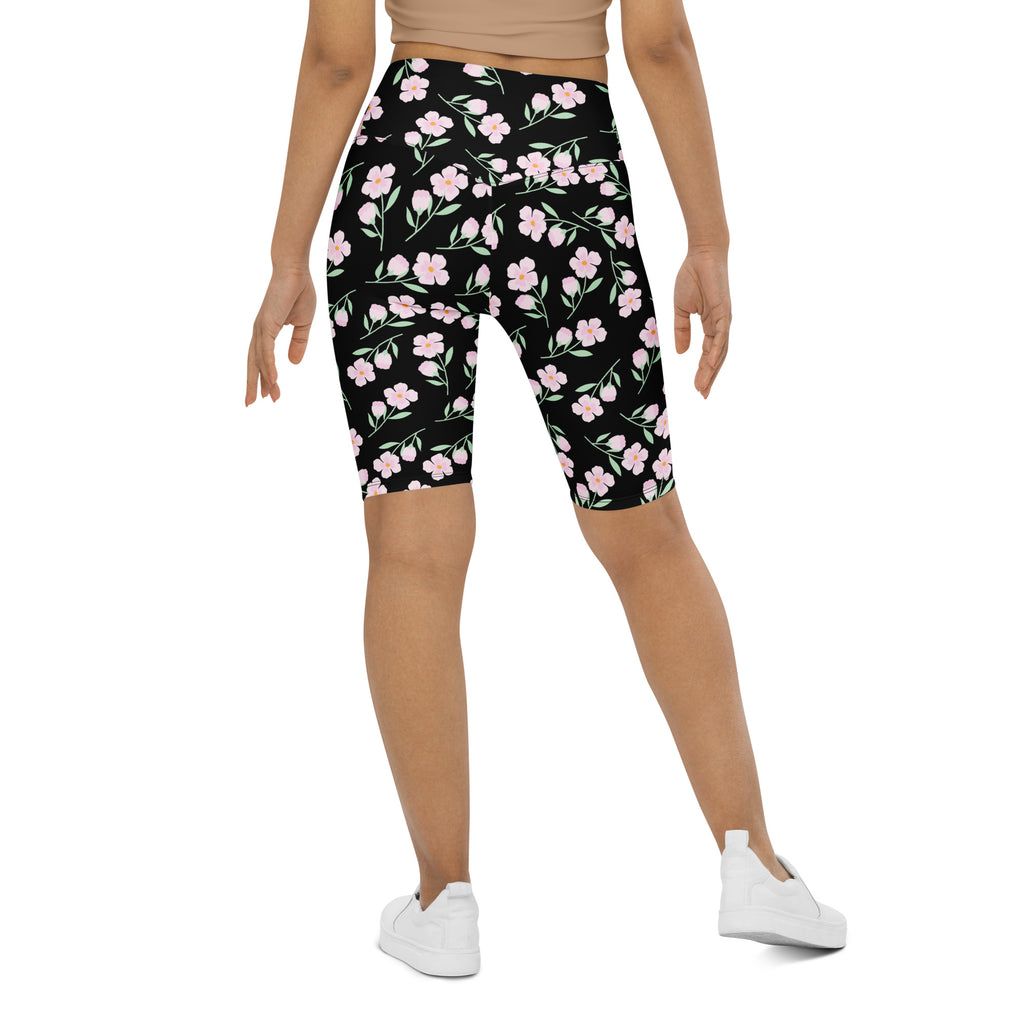 Women’s pink blossom high waisted bike shorts with moisture wicking fabric featuring black floral pattern