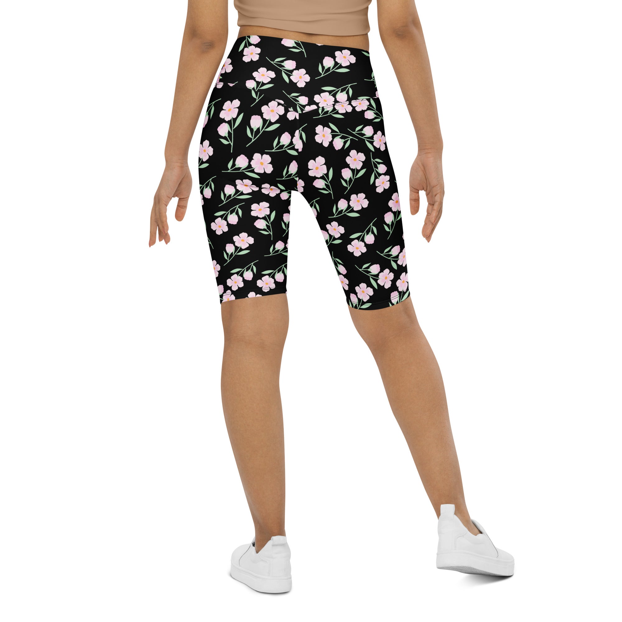 Women’s pink blossom high waisted bike shorts with moisture wicking fabric featuring black floral pattern