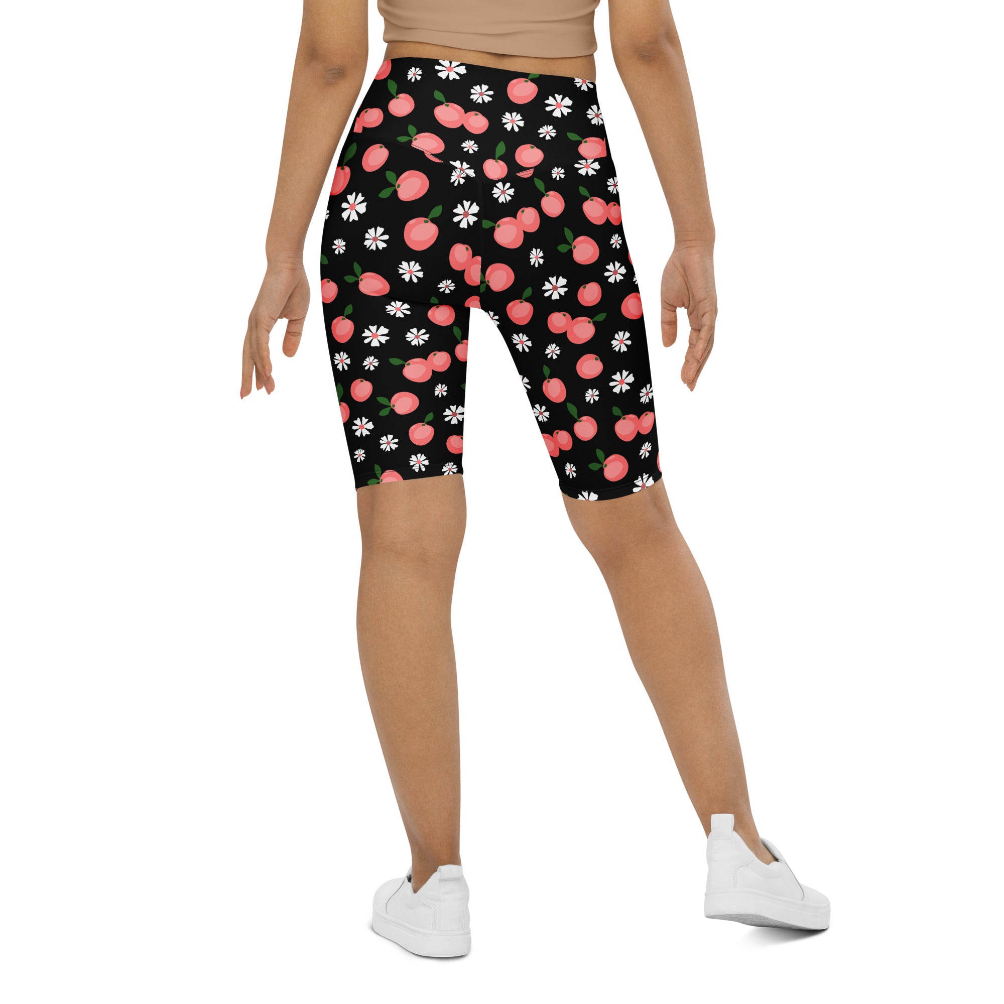 Women’s black high waisted moisture wicking bike shorts with pink peach and white daisy pattern for active fit
