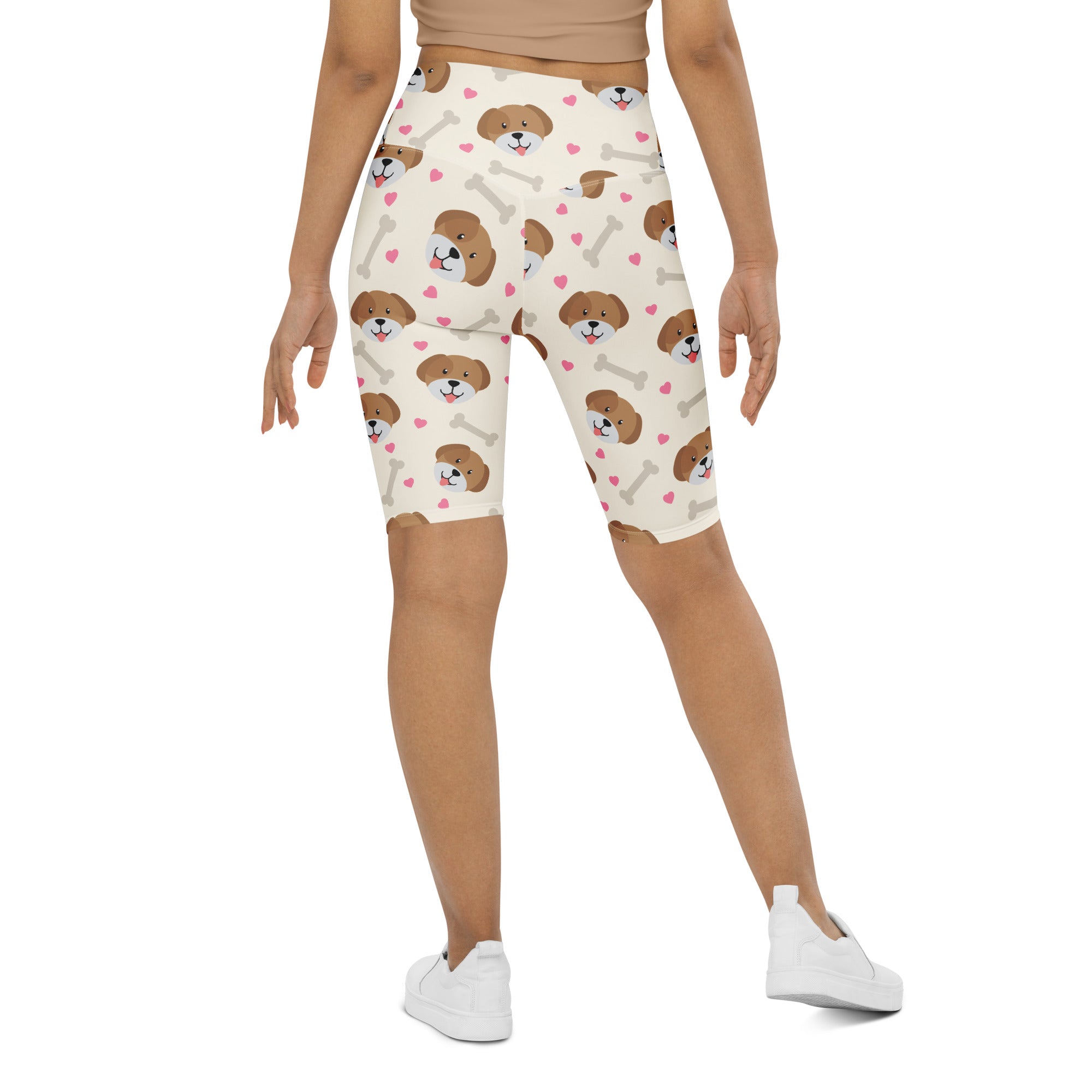 Cream-colored women’s high waisted biker shorts with moisture wicking fabric and puppy face pattern with hearts and bones
