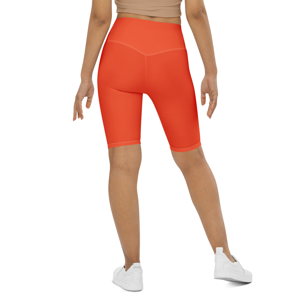 Bright orange women’s high waisted biker shorts with moisture wicking stretchy fabric for active fit