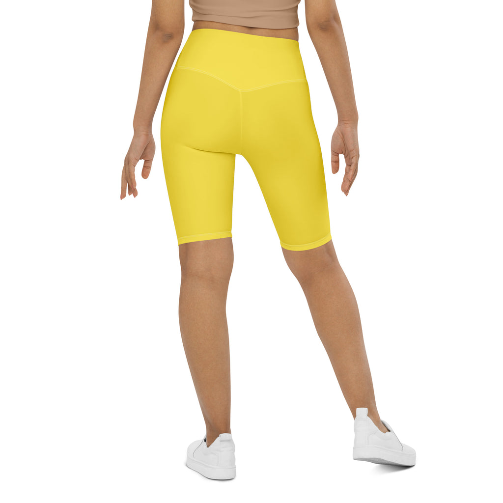 Bright yellow high waisted bike shorts made of stretchy moisture wicking fabric for active fit women