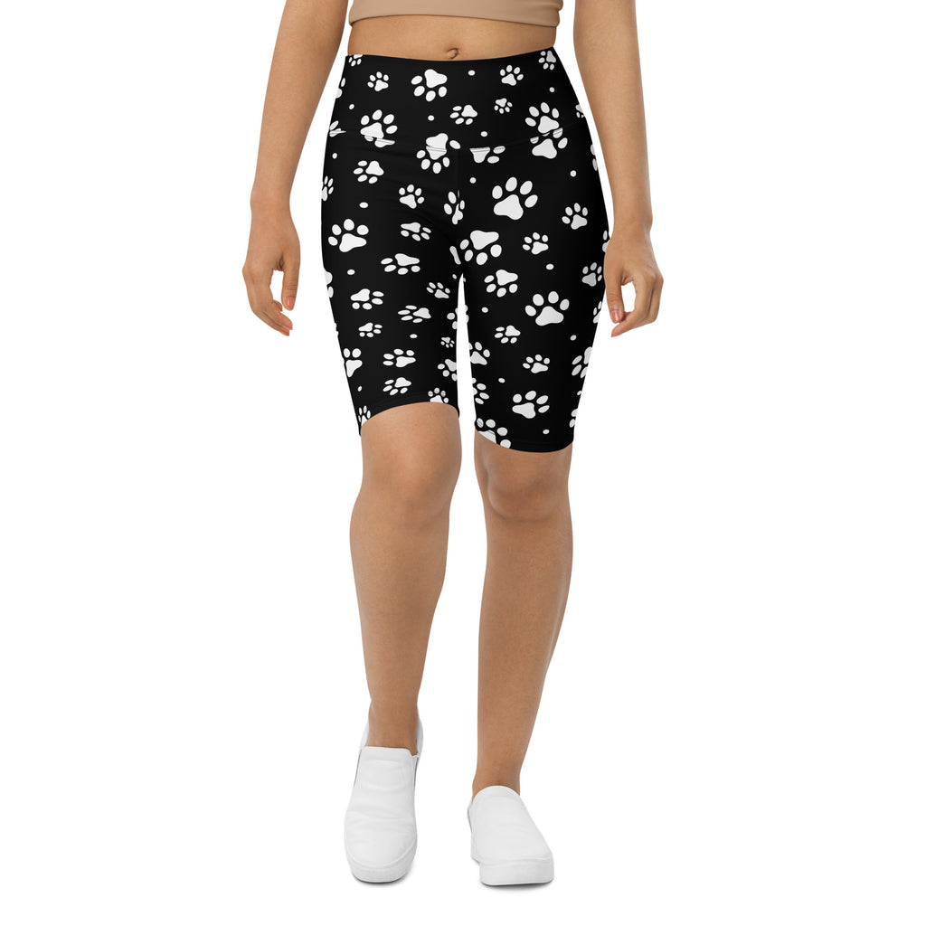 Women’s black high waisted moisture wicking biker shorts with white paw print pattern for active fit