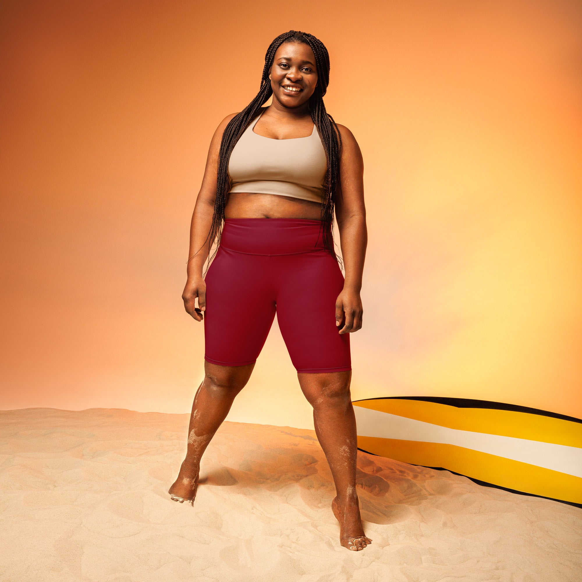 The model is wearing women’s burgundy high waisted biker shorts with moisture wicking, stretchy fabric for active fit