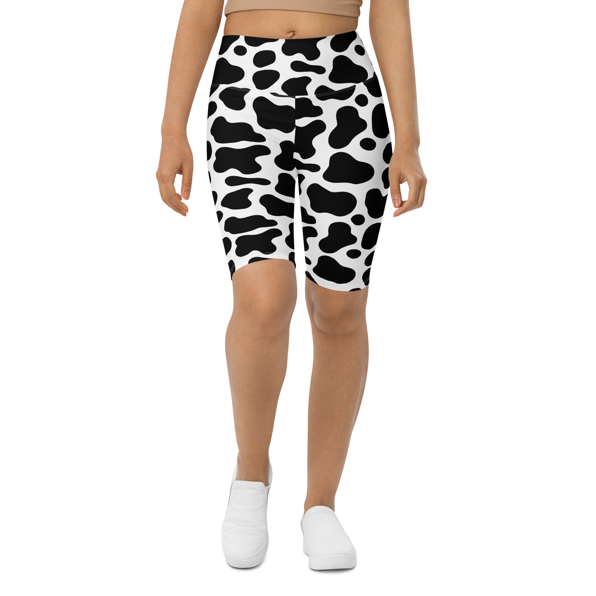 Women’s cow print high waisted biker shorts with black and white moisture wicking active fit shown from the back