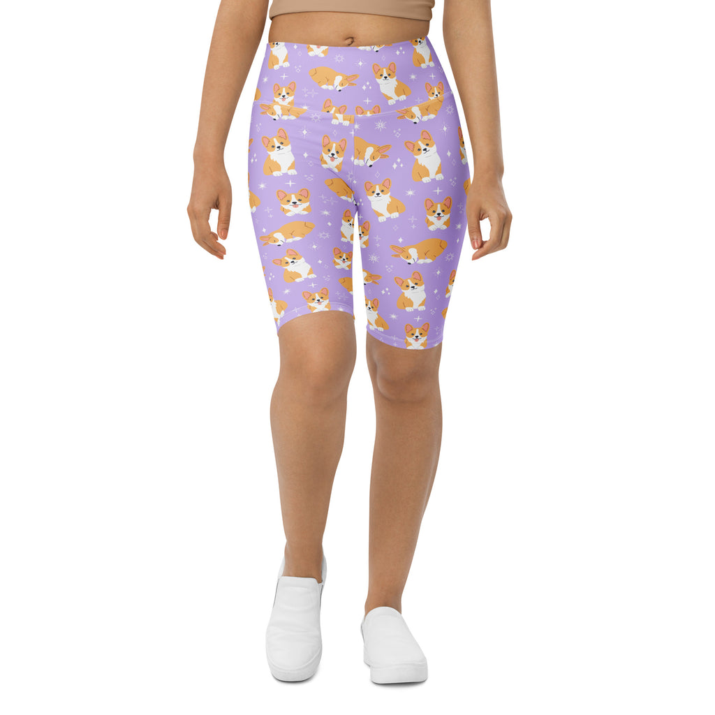 Women’s purple high waisted biker shorts with moisture wicking fabric featuring orange and white corgi dog pattern