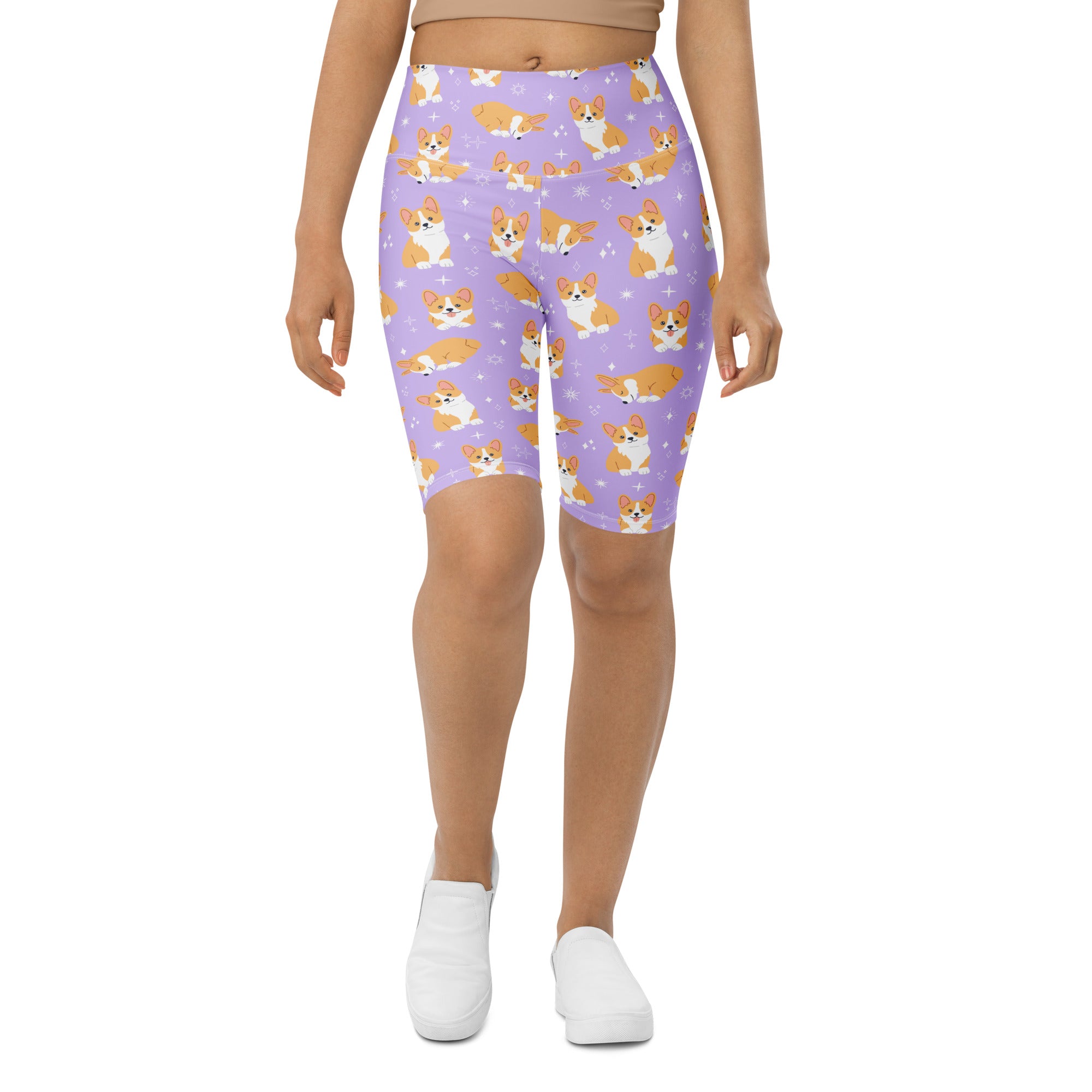 Women’s purple high waisted biker shorts with moisture wicking fabric featuring orange and white corgi dog pattern