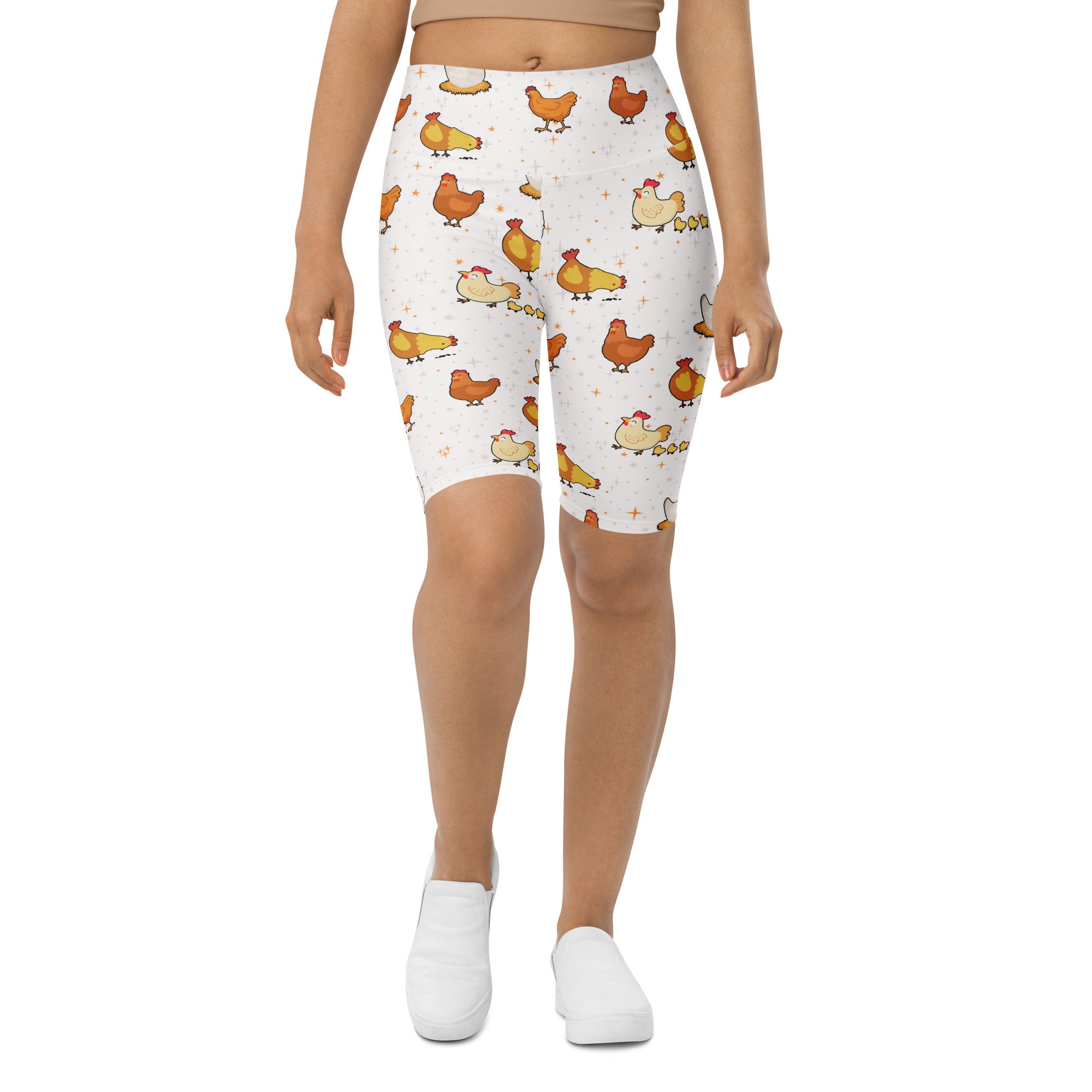 White high waisted biker shorts with moisture wicking fabric featuring a playful orange and yellow cartoon chicken pattern