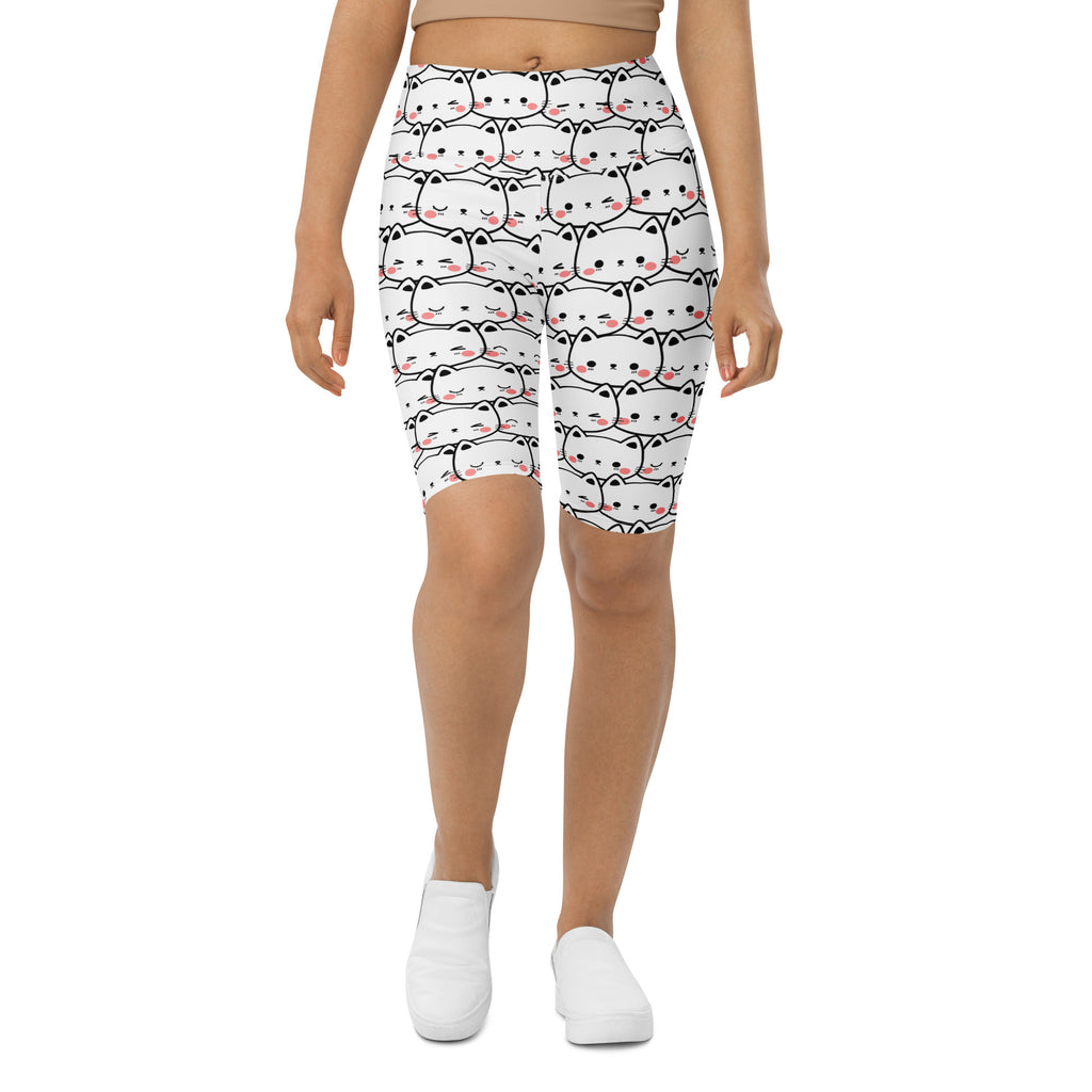 White high waisted moisture wicking bike shorts with a playful black outlined cartoon cat pattern for women