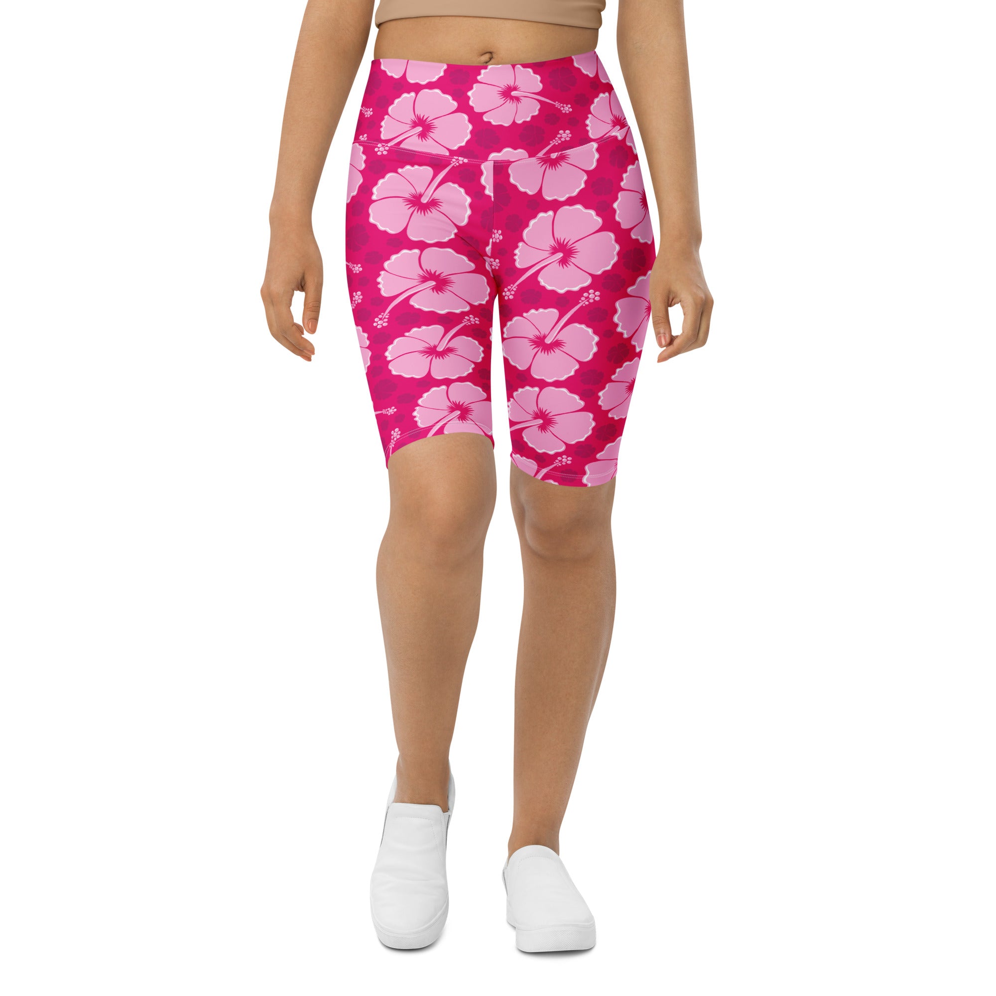 Women pink hibiscus high waisted biker shorts with moisture wicking fabric and active fit shown from the back side