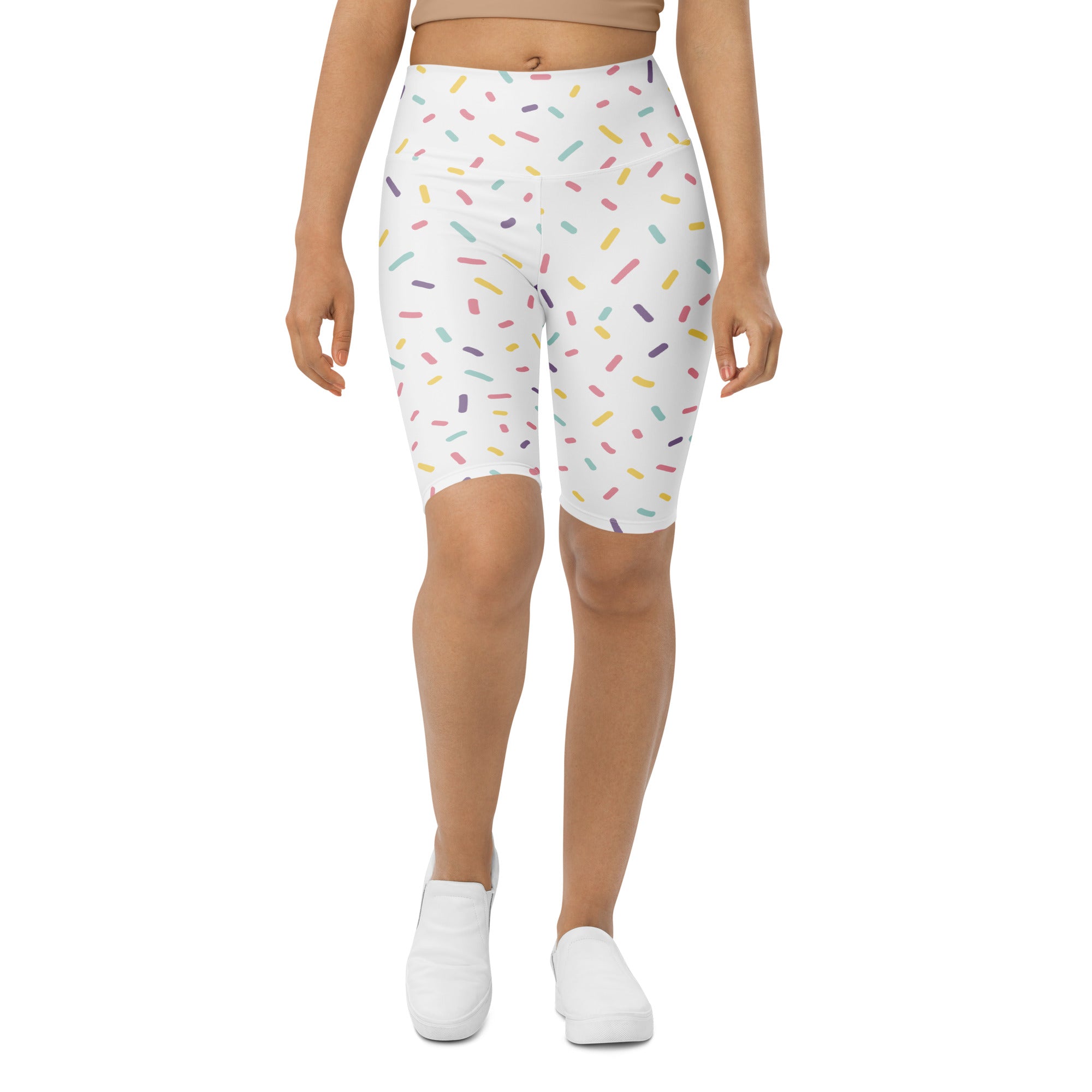 White high waisted bike shorts with a playful multicolored sprinkle print and moisture wicking active fit