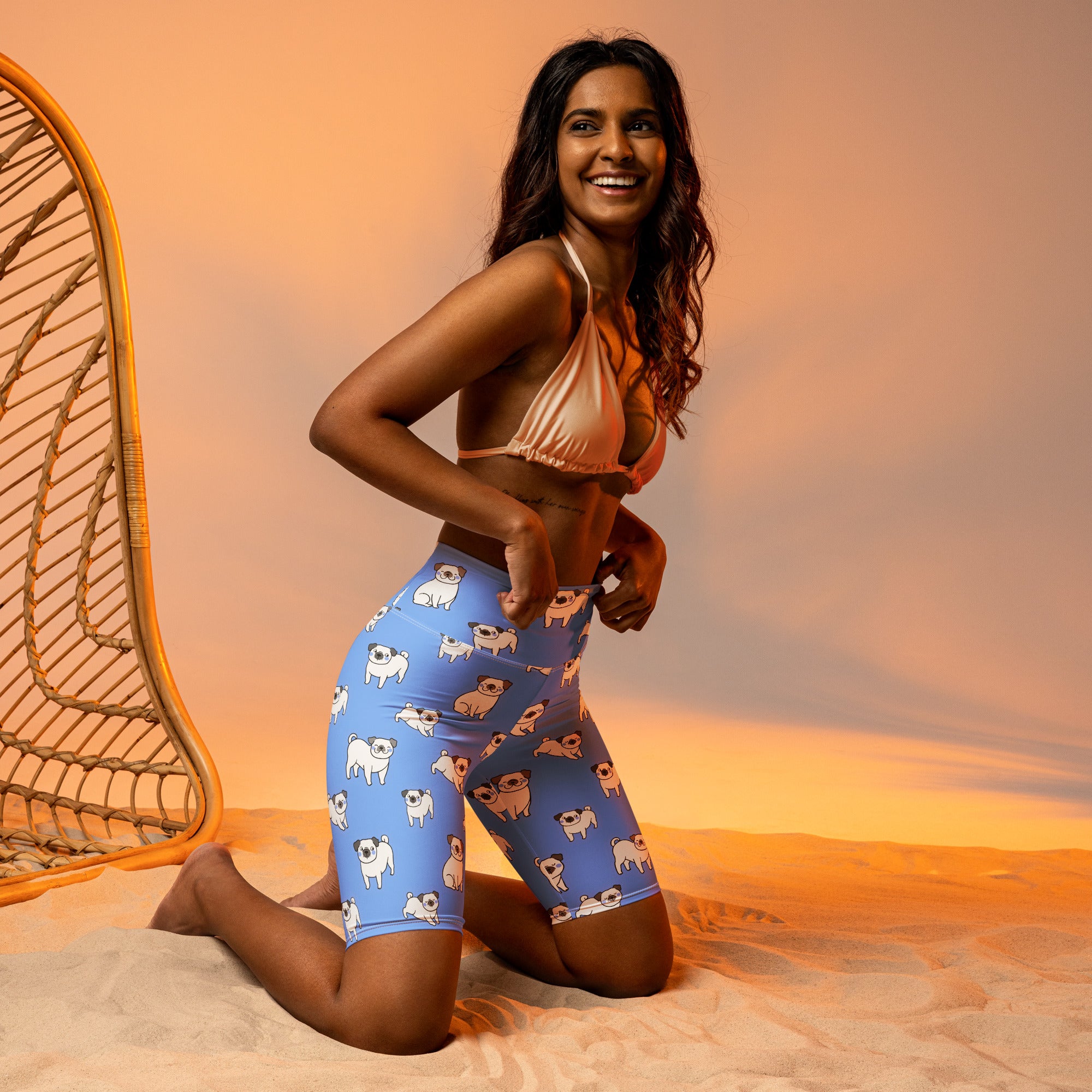 Women’s blue high waisted biker shorts with moisture wicking fabric featuring playful cartoon pug patterns