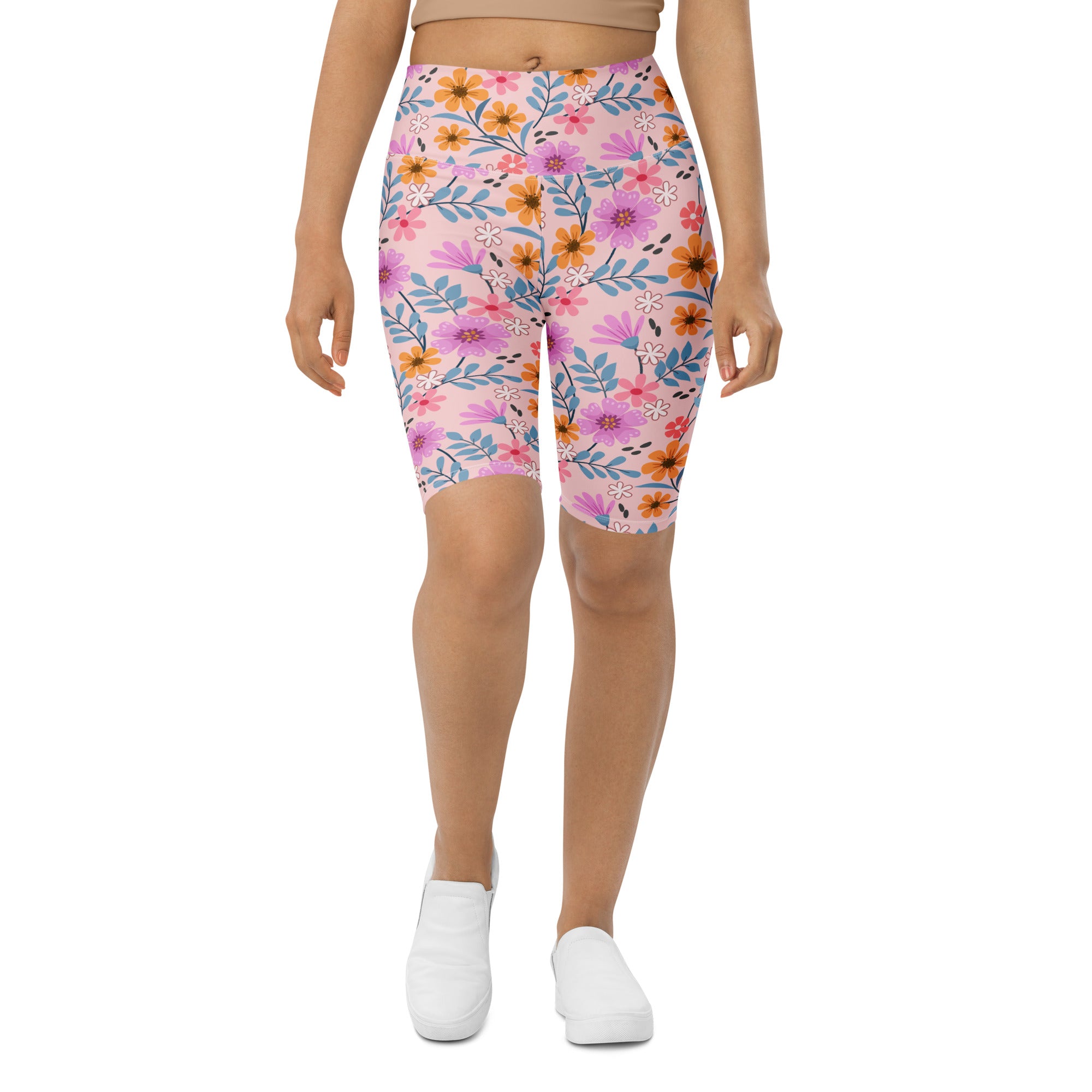 Women’s pink floral high waisted biker shorts with vibrant purple orange and blue blossoms moisture wicking fit