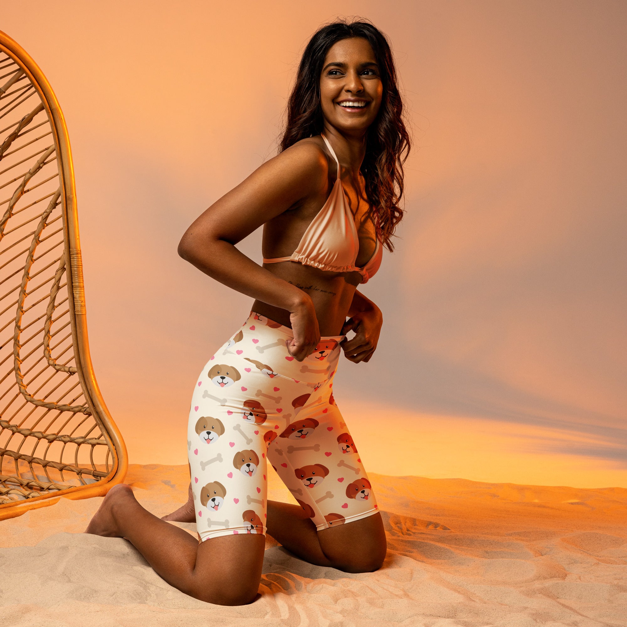 Women’s white high waisted moisture wicking bike shorts with playful brown puppy faces and bone pattern
