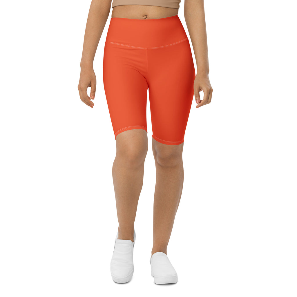 Bright orange high waisted biker shorts made of stretchy moisture wicking fabric for active fit performance