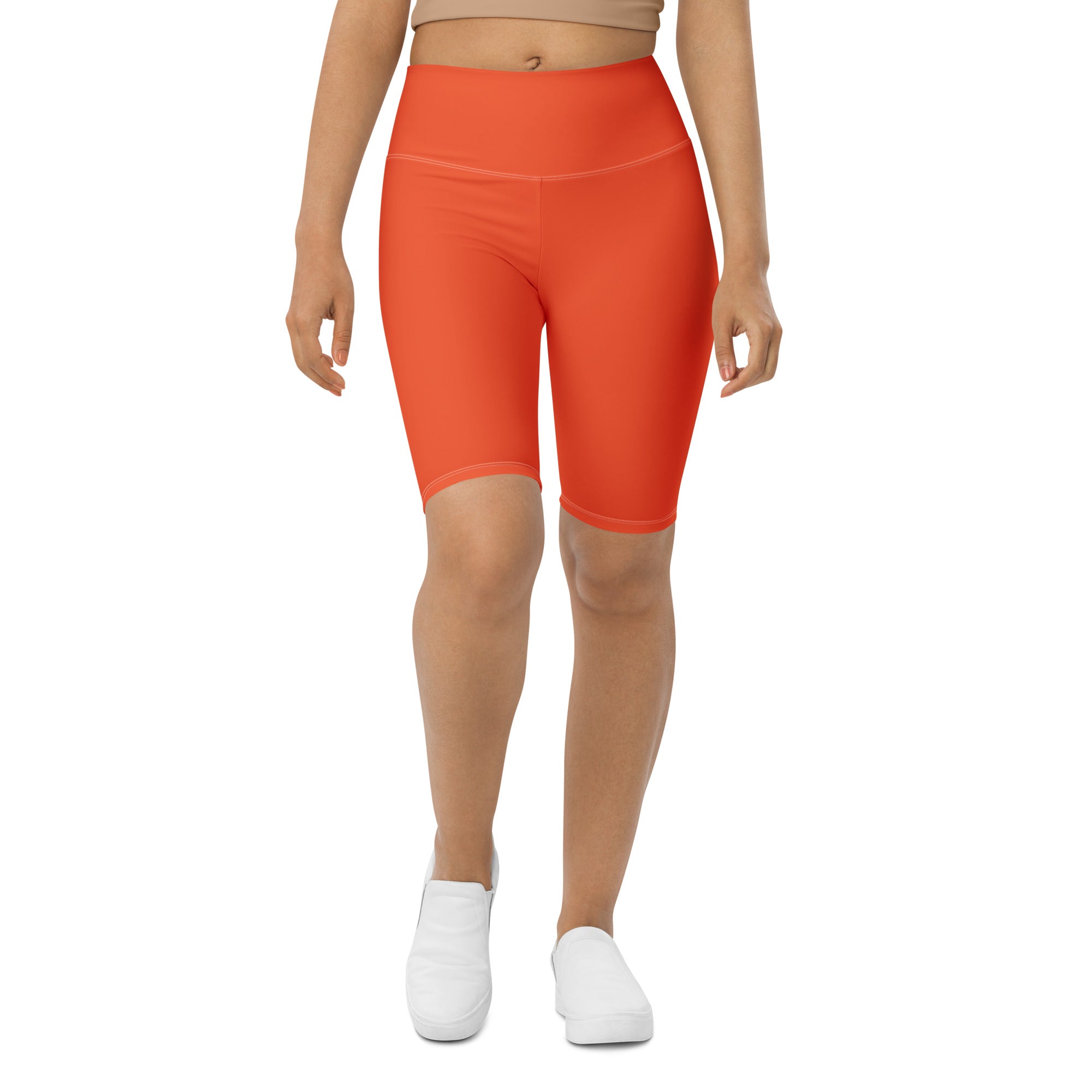 Bright orange high waisted biker shorts made of stretchy moisture wicking fabric for active fit performance