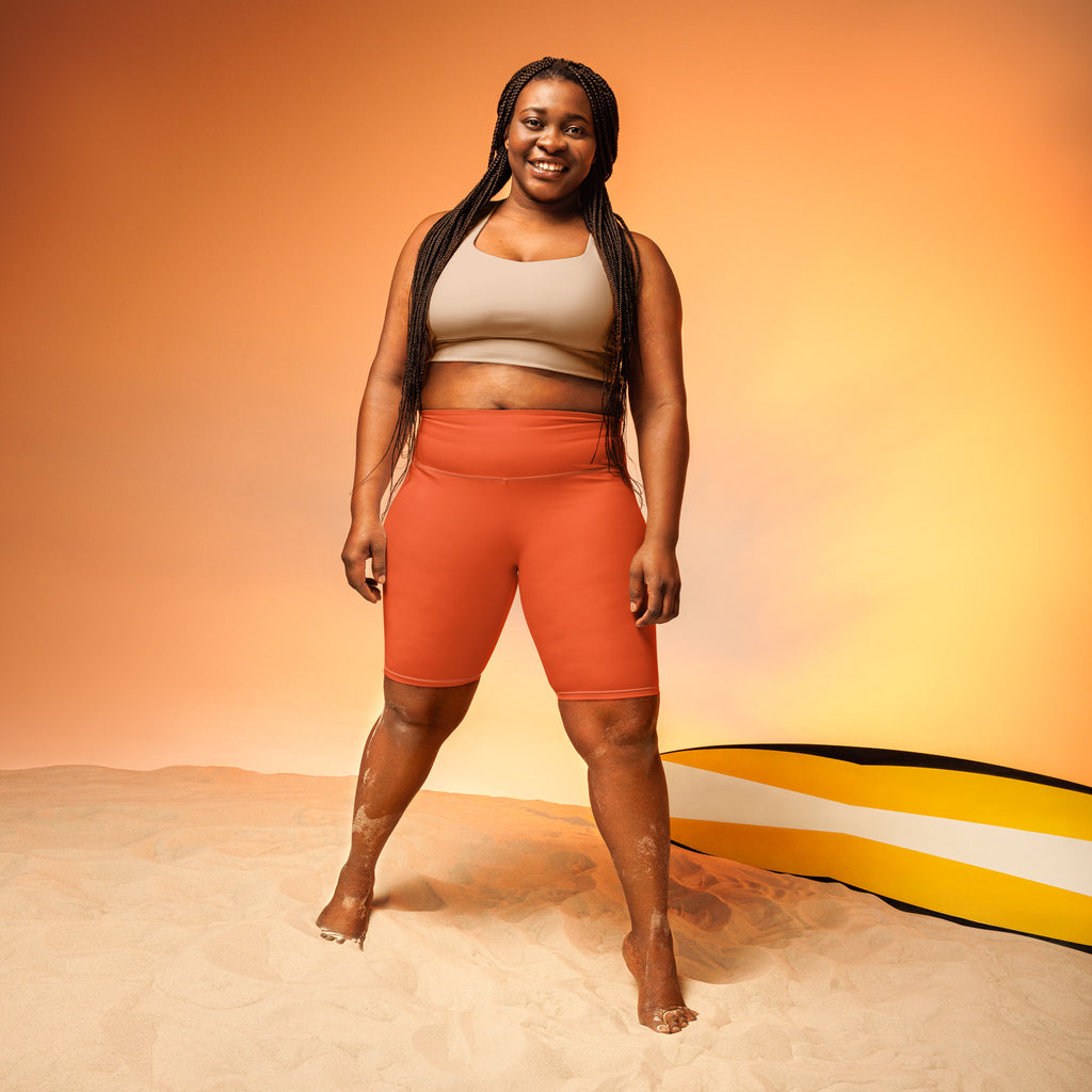 Women’s orange high waisted biker shorts with moisture wicking fabric for active fit workouts