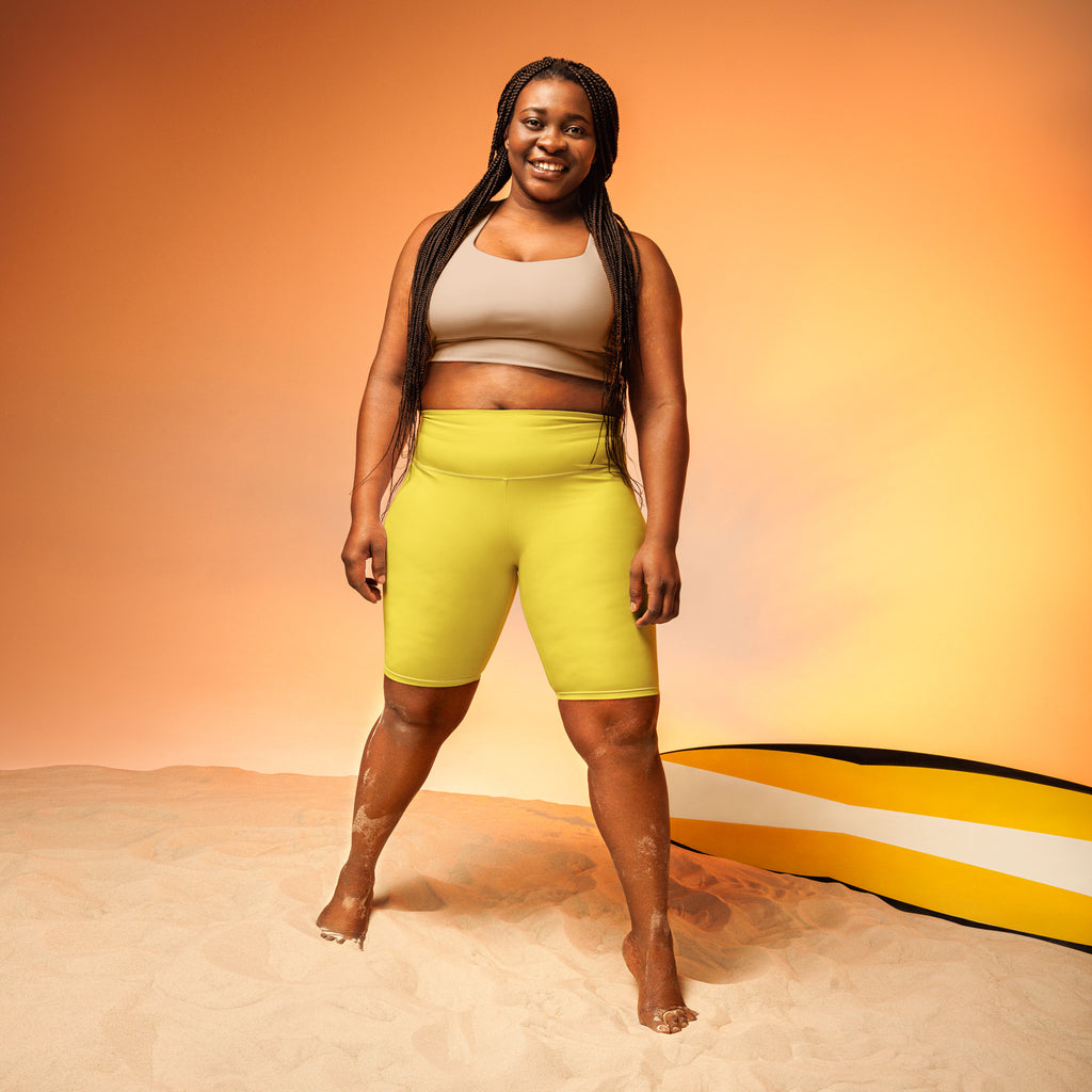 Women’s yellow high waisted biker shorts with moisture wicking fabric for an active fit