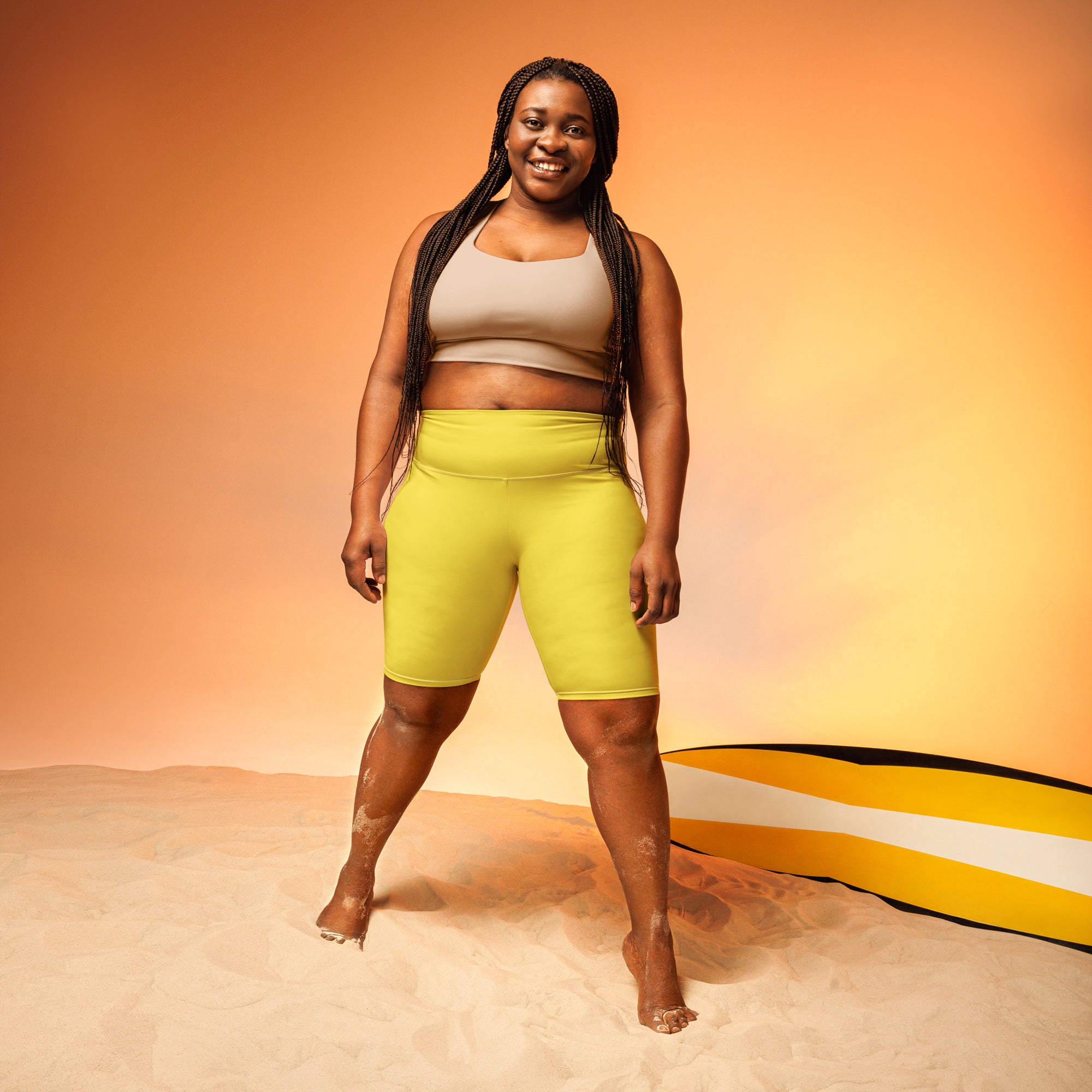 Women’s yellow high waisted biker shorts with moisture wicking fabric for an active fit