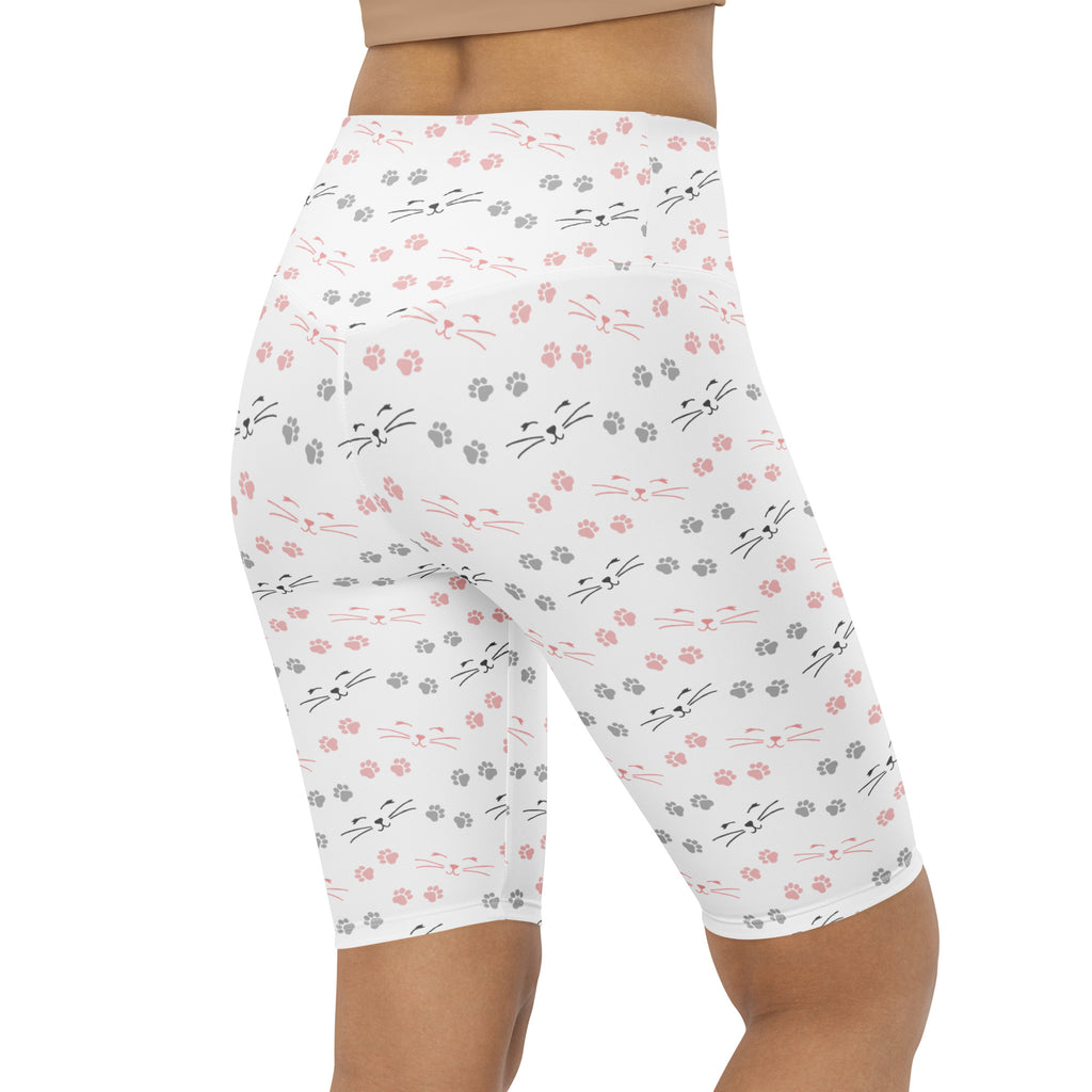 White high waisted bike shorts with pink and gray cat faces and paw prints moisture wicking active fit