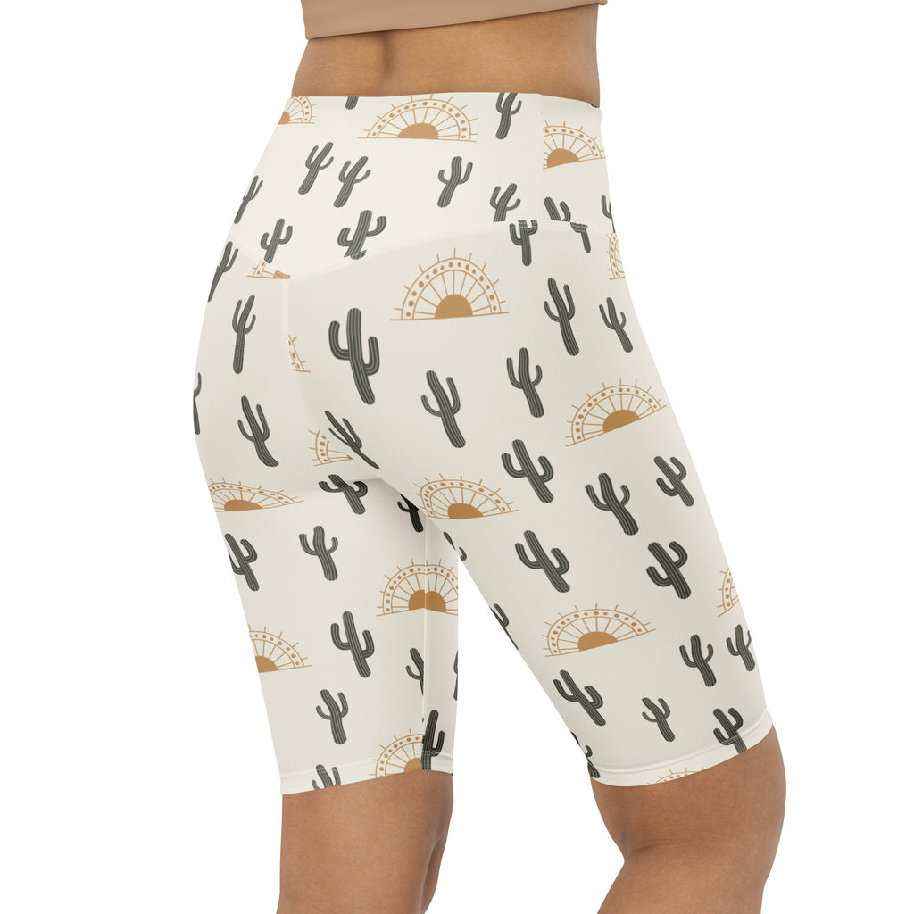 Cream-colored high waisted bike shorts with black cactus and gold sunburst pattern moisture wicking active fit