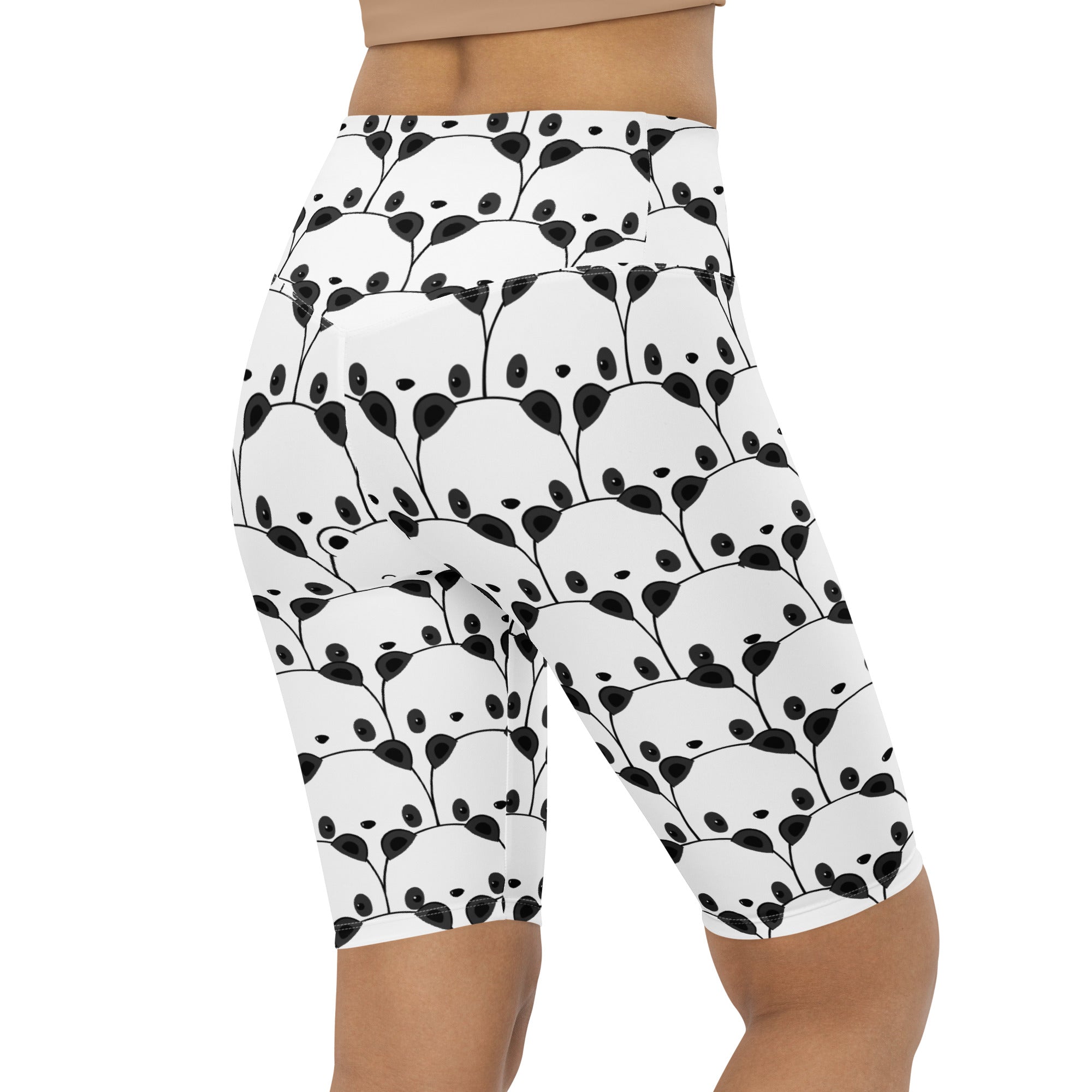 White high waisted bike shorts with moisture wicking fabric featuring a playful black panda face and abstract leaf design
