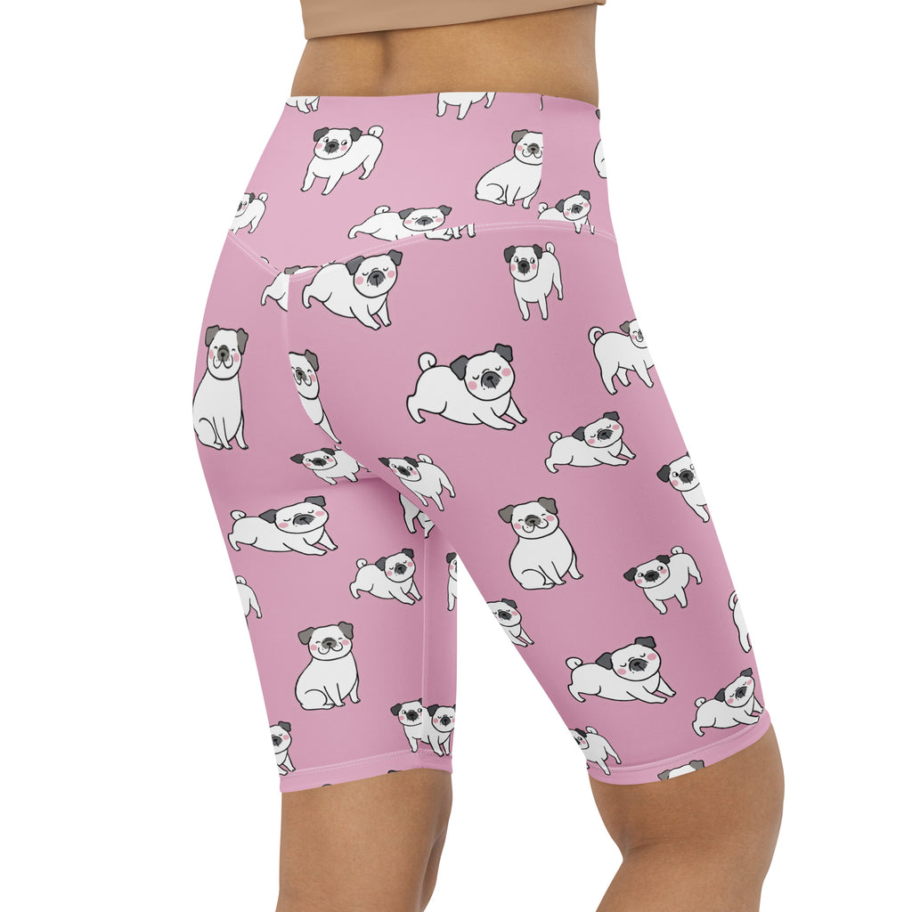 Women’s pink high waisted moisture wicking biker shorts with playful white cartoon pug pattern for active fit