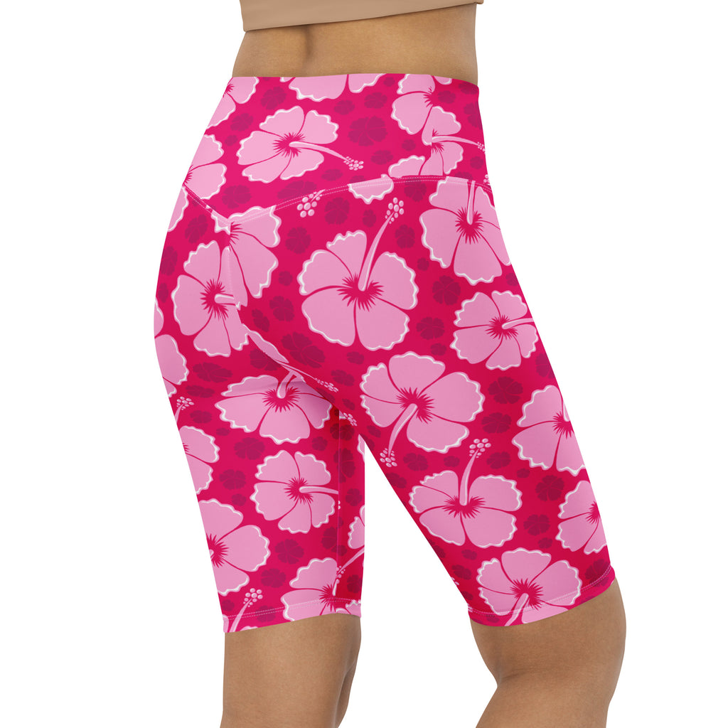 Women’s pink hibiscus high waisted biker shorts with moisture wicking fabric and vibrant fuchsia floral pattern
