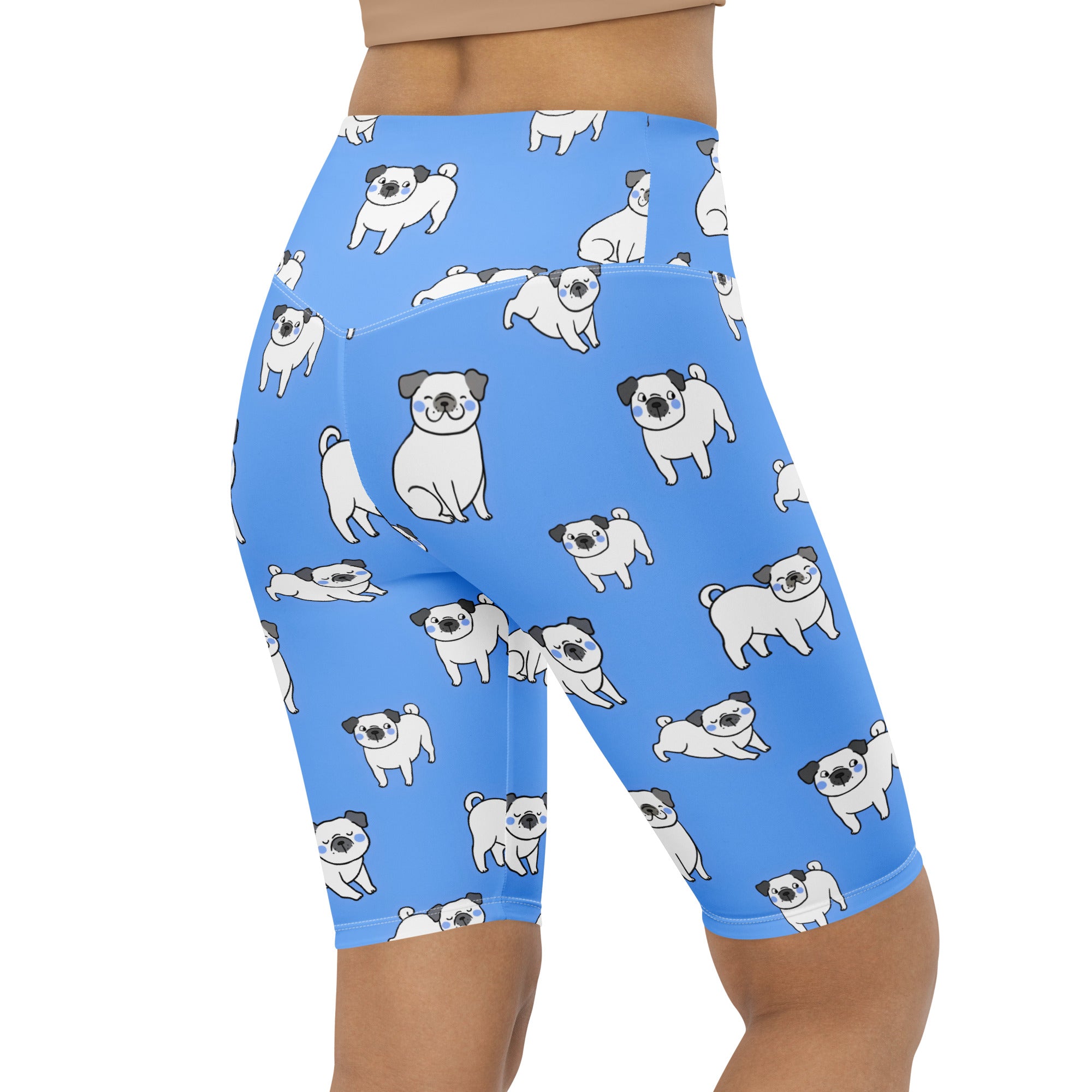 Women’s blue high waisted moisture wicking biker shorts with a playful cartoon pug pattern for active fit use