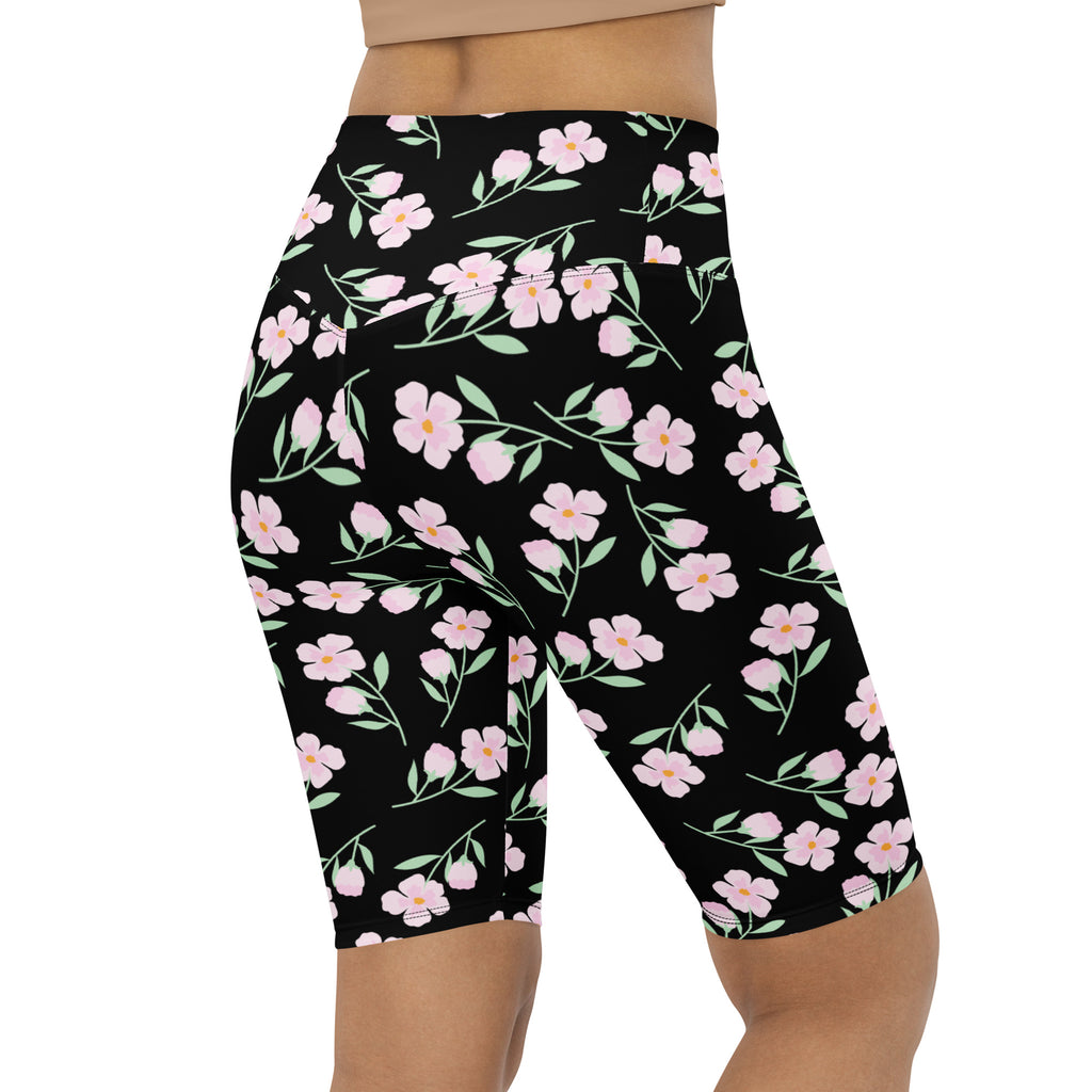Women’s black floral high waisted biker shorts with pink blossoms moisture wicking active fit material