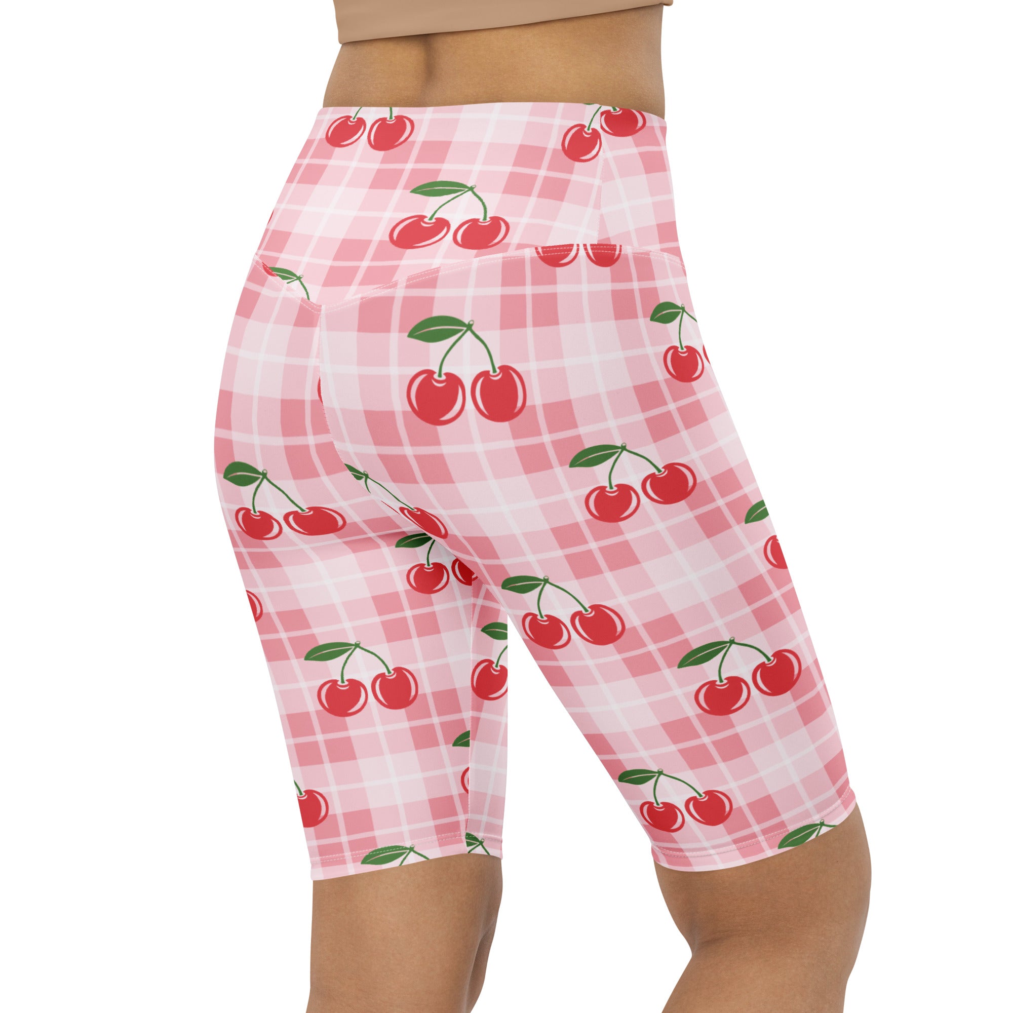 Women’s pink gingham cherry high waisted biker shorts with moisture wicking fabric and playful red cherry pattern
