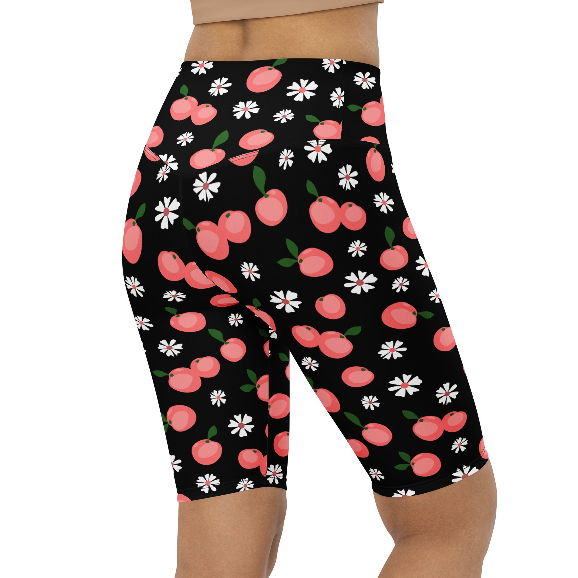 Women’s black high waisted moisture wicking biker shorts with pink cherries and white daisies pattern