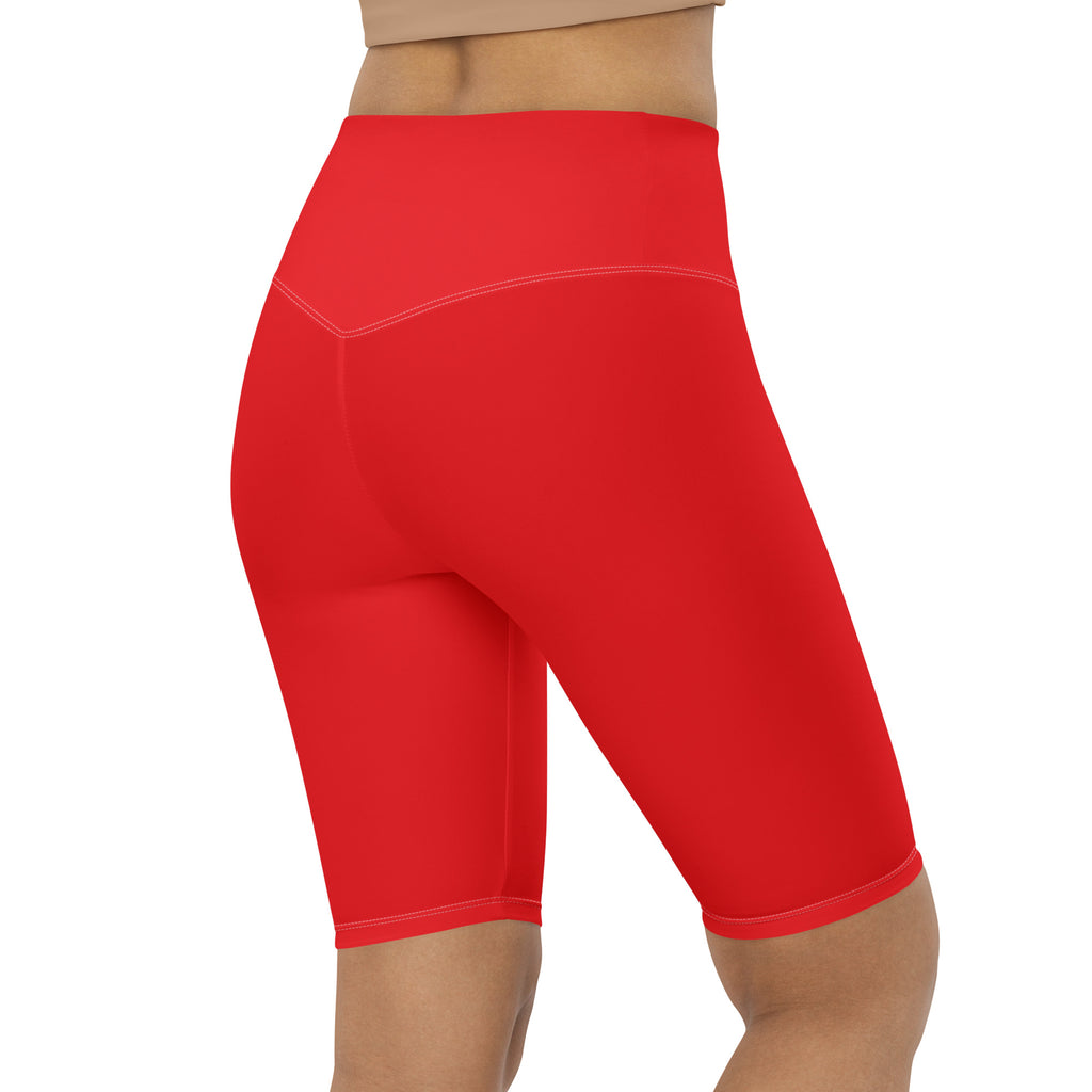 Women’s red high waisted biker shorts with moisture wicking smooth fabric and subtle white stitching along seams