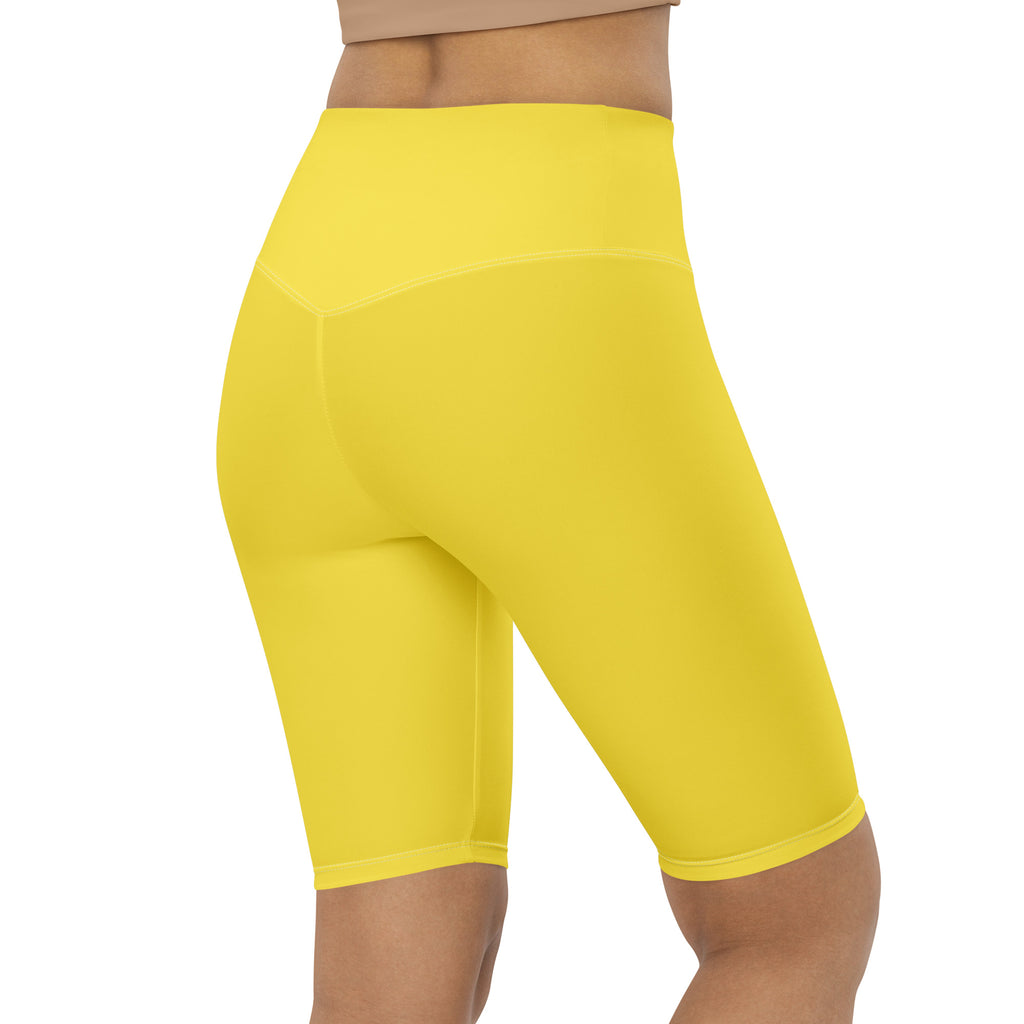 Bright yellow women’s high waisted biker shorts with smooth stretchy fabric and moisture wicking active fit