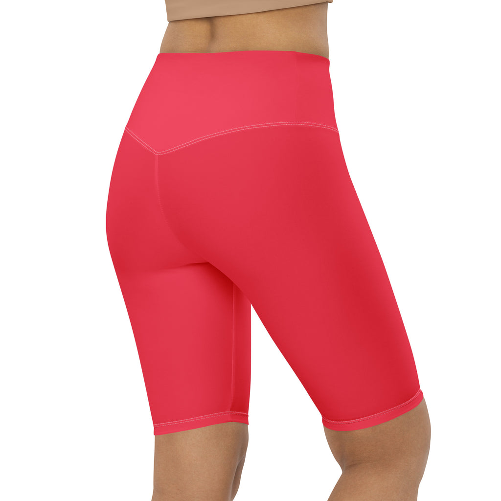 Bright coral high waisted biker shorts with smooth stretchy fabric and subtle seam detailing for active fit use