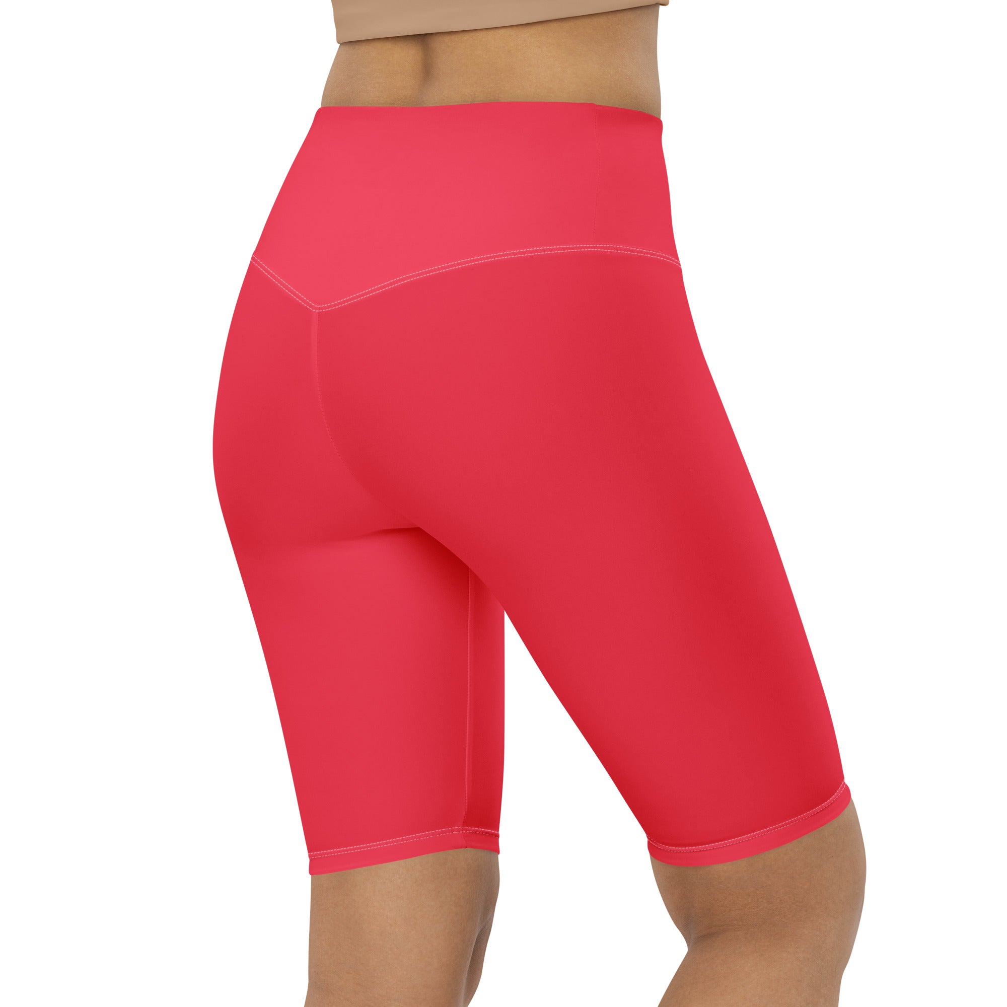 Bright coral high waisted biker shorts with smooth stretchy fabric and subtle seam detailing for active fit use