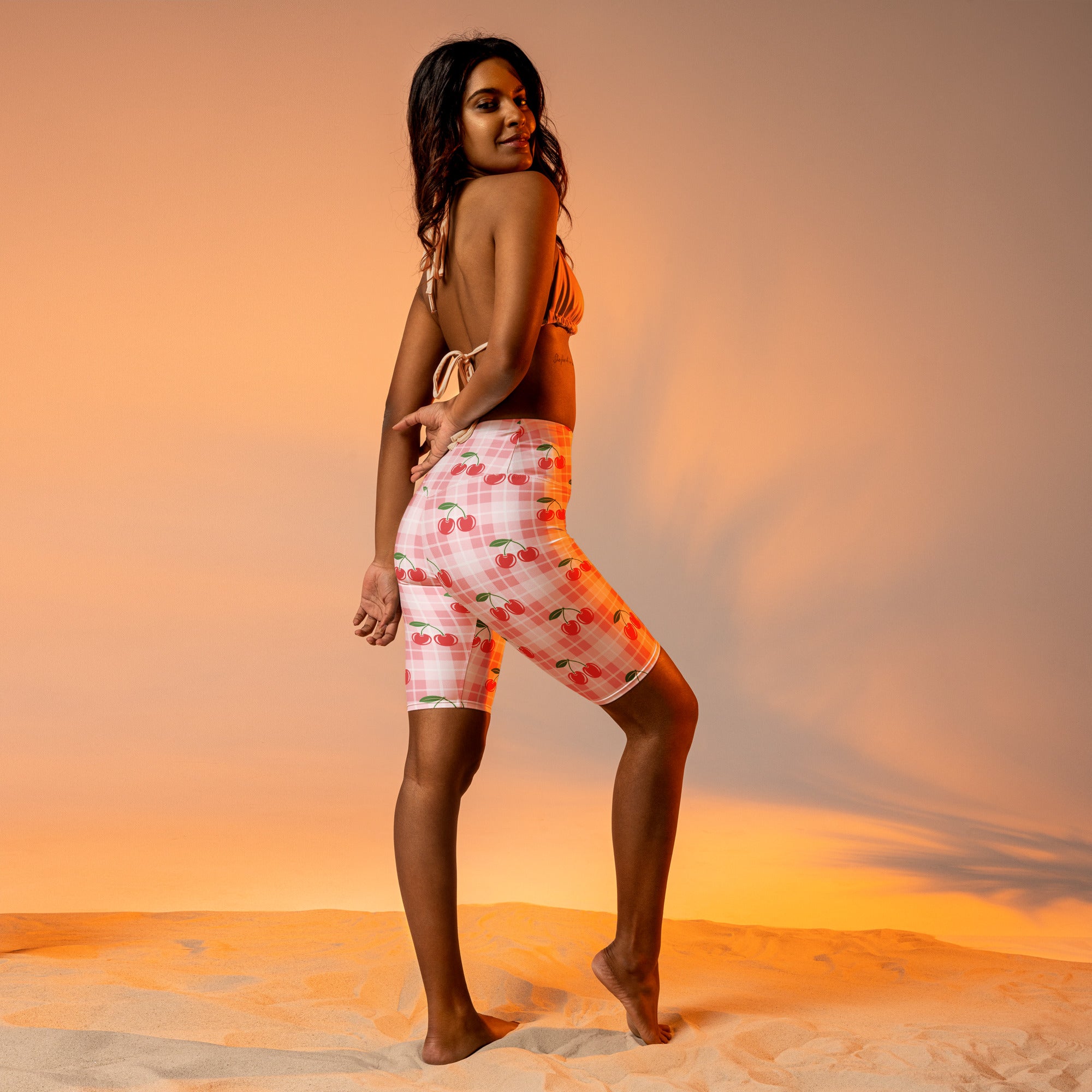 Women’s pink gingham cherry high waisted biker shorts with moisture wicking fabric and plaid pattern