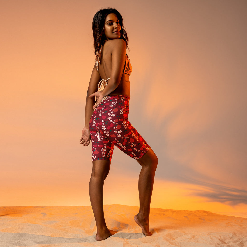 Women’s burgundy cherry daisy high waisted biker shorts with moisture wicking fabric and red floral pattern with white blossoms