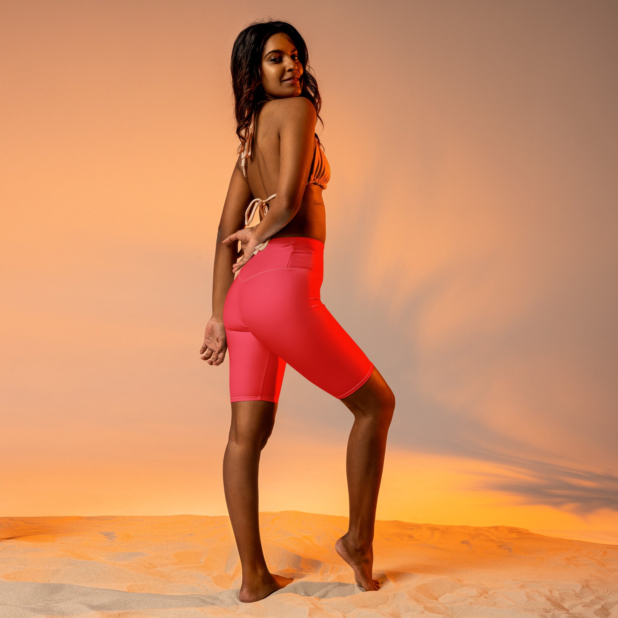 Women’s bright pink high waisted biker shorts with sleek form fitting moisture wicking active fit design