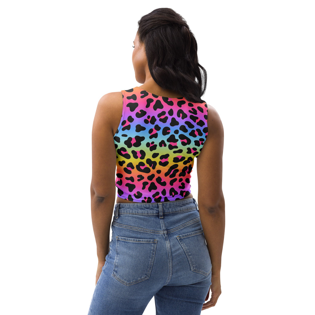 A vibrant rainbow leopard print buttery soft crop top with black spots worn by a woman for pride events