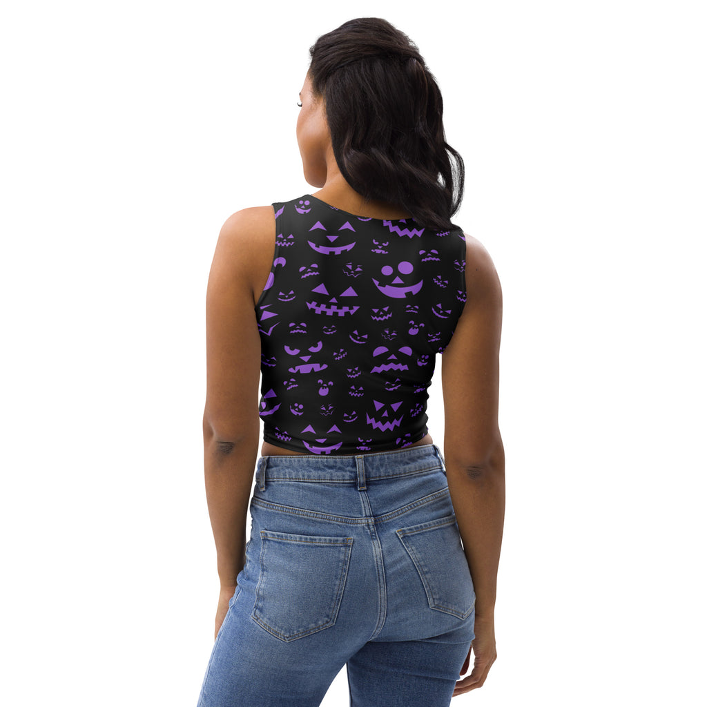 Black sleeveless buttery soft crop top with purple jack o lantern face patterns for women’s Halloween wear