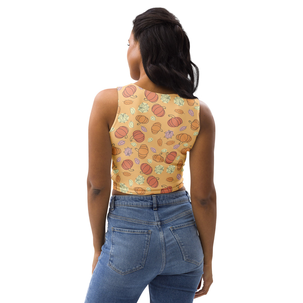 Women’s pumpkin patch autumn buttery soft crop top in mustard yellow with orange pumpkins and pastel autumn leaves pattern