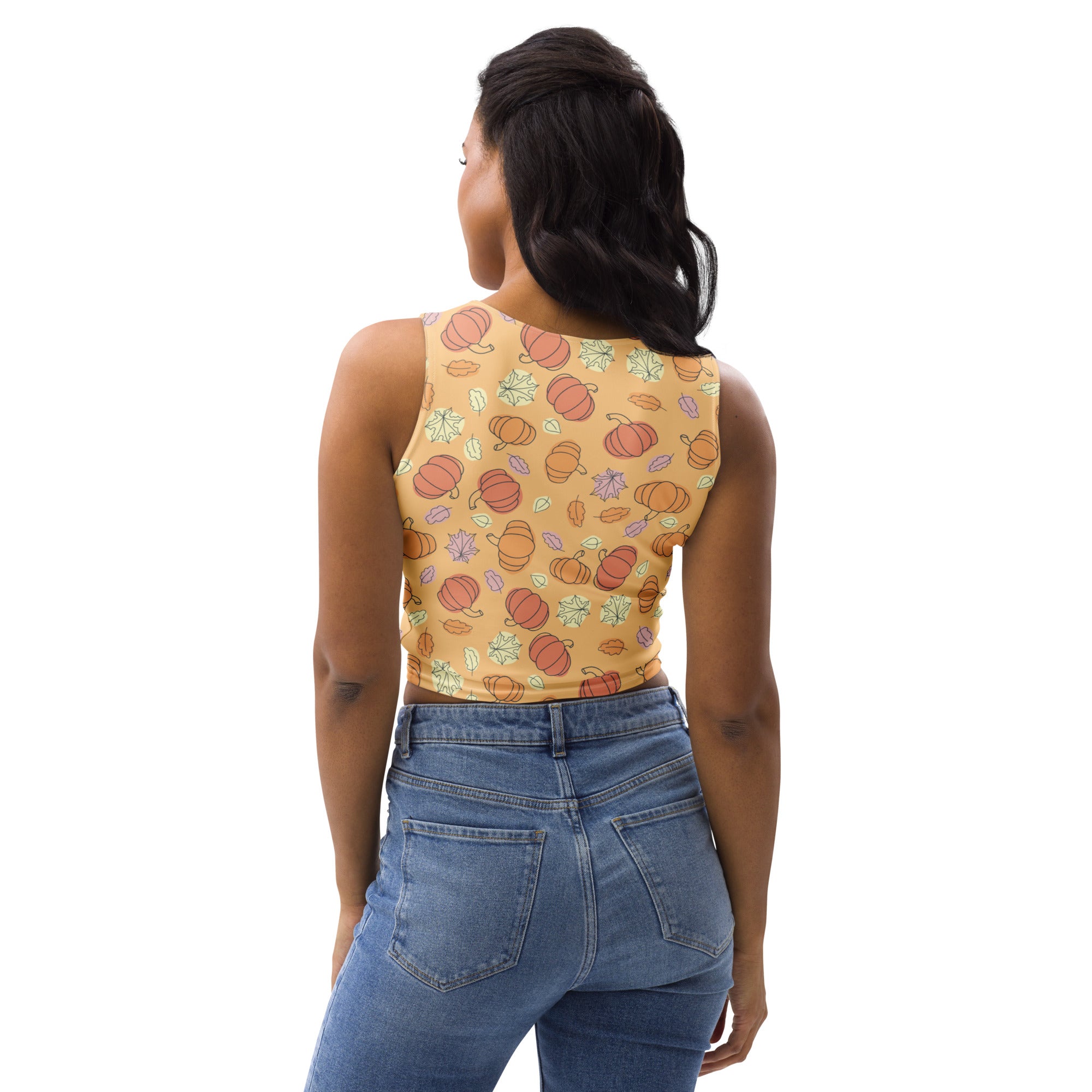 Women’s pumpkin patch autumn buttery soft crop top in mustard yellow with orange pumpkins and pastel autumn leaves pattern