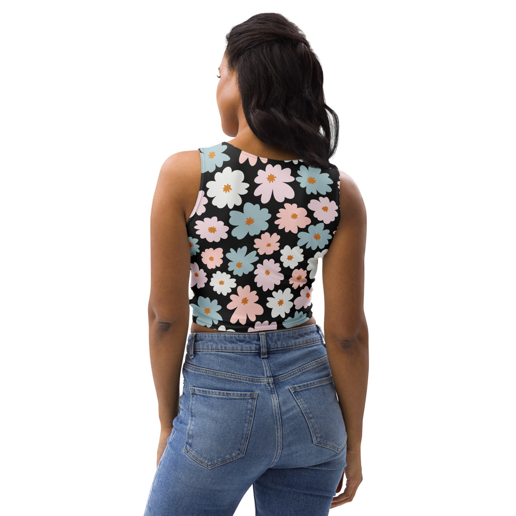 A black sleeveless buttery soft crop top with pastel pink white and light blue daisy patterns for women