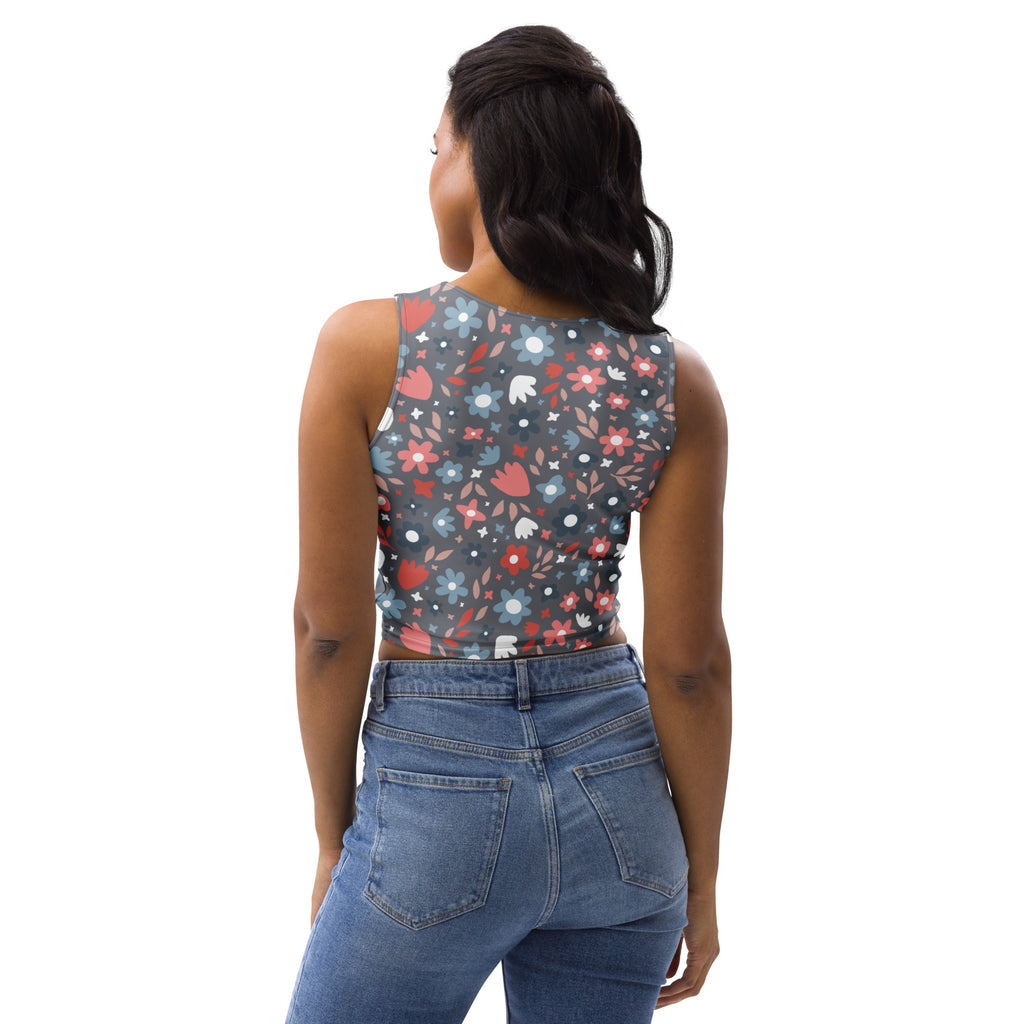 Women’s dark floral buttery soft sleeveless cropped top in dark gray with vibrant red pink and blue flowers and white stars