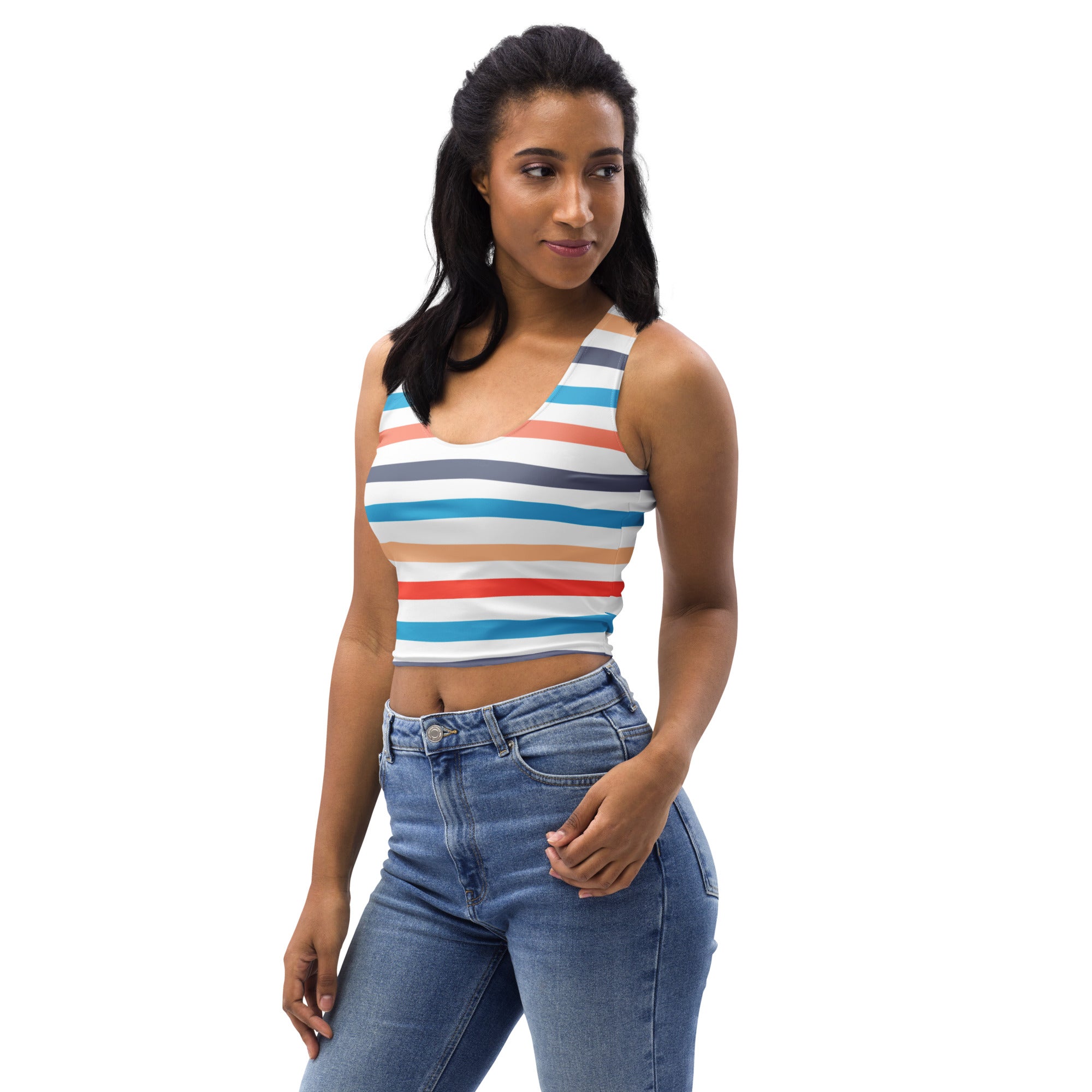 A woman wearing a women’s retro sunset stripes buttery soft crop top with colorful white blue red and gray horizontal bands