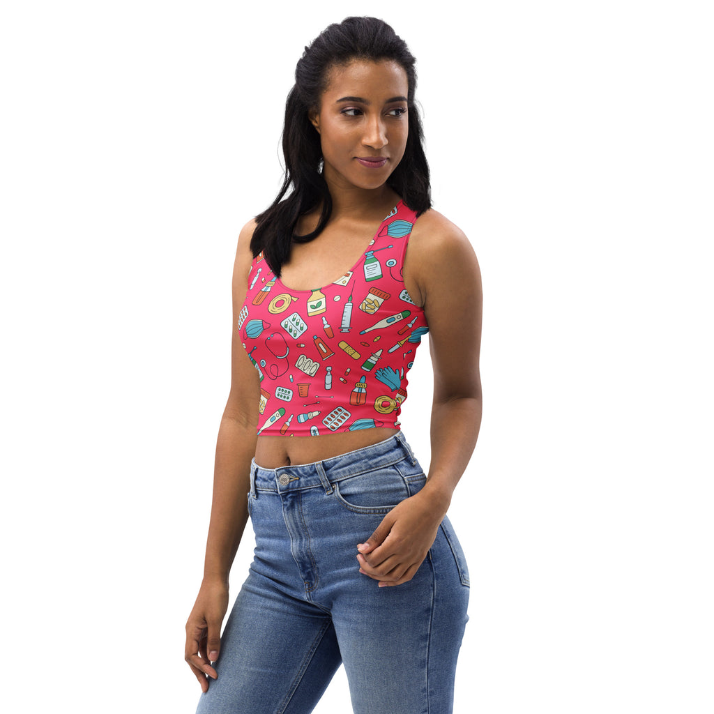 Women’s nurse-themed buttery soft pink crop top with playful blue green and white medical pattern