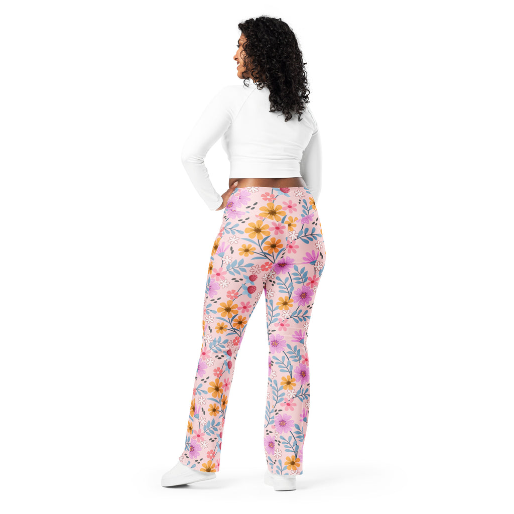 Women’s pink high waist flare leggings with vibrant yellow purple and blue floral pattern