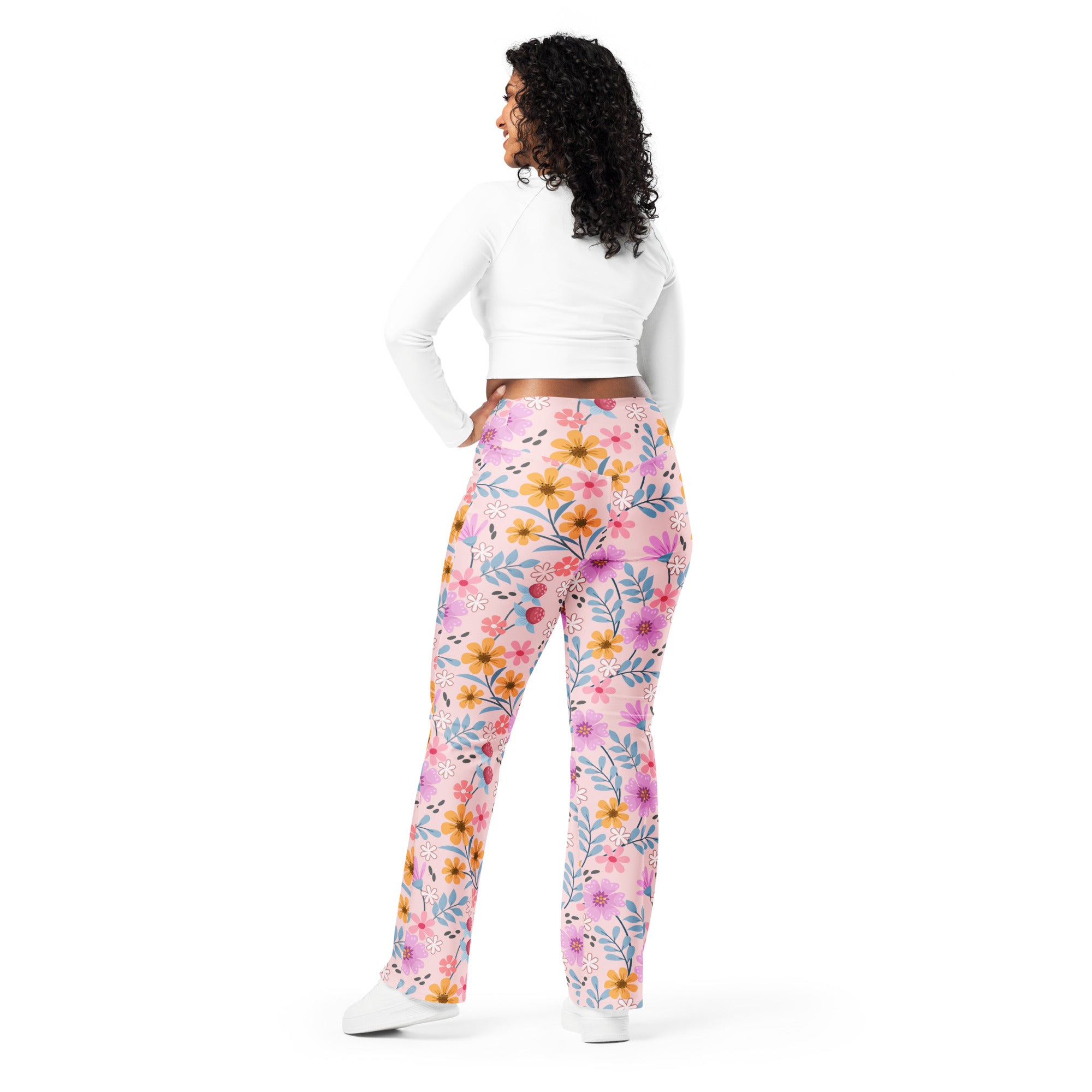 Women’s pink high waist flare leggings with vibrant yellow purple and blue floral pattern